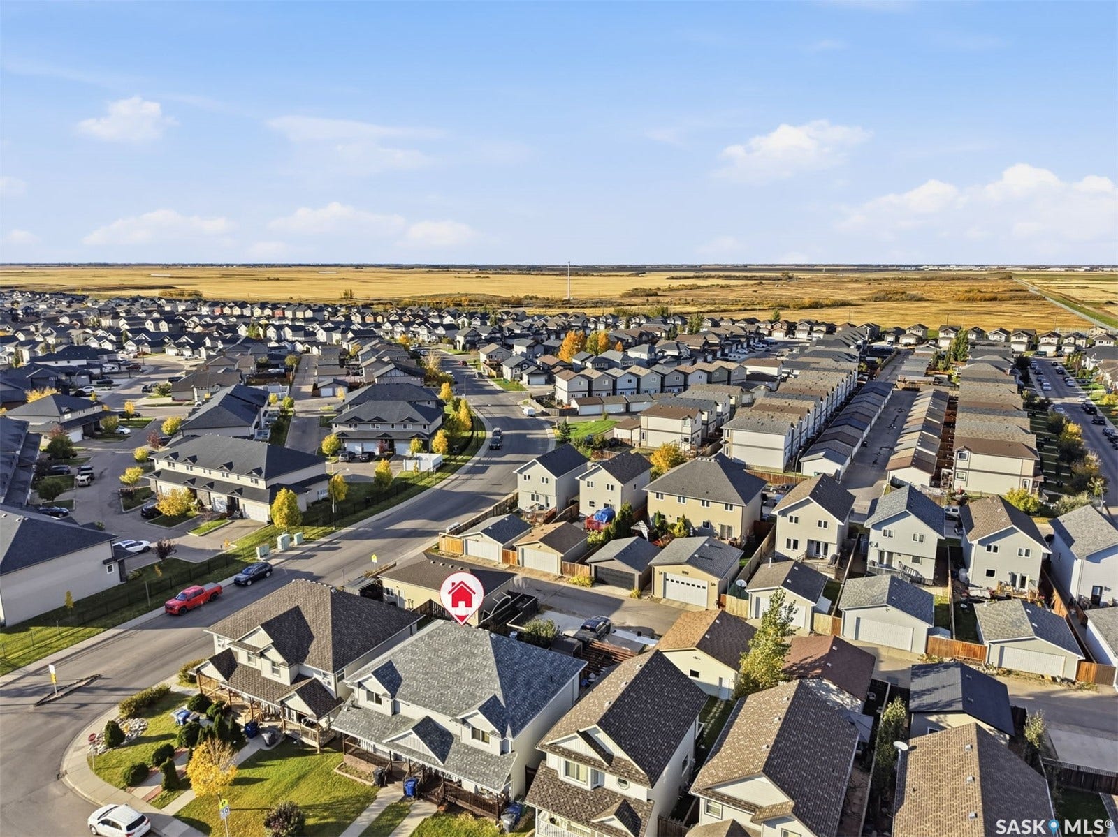 Residential neighborhood with detached homes featuring asphalt shingle roofs and paved streets