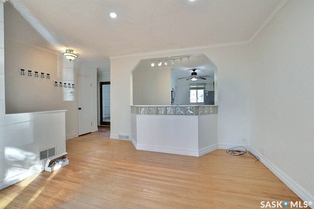 Light wood-finish flooring extending through the space