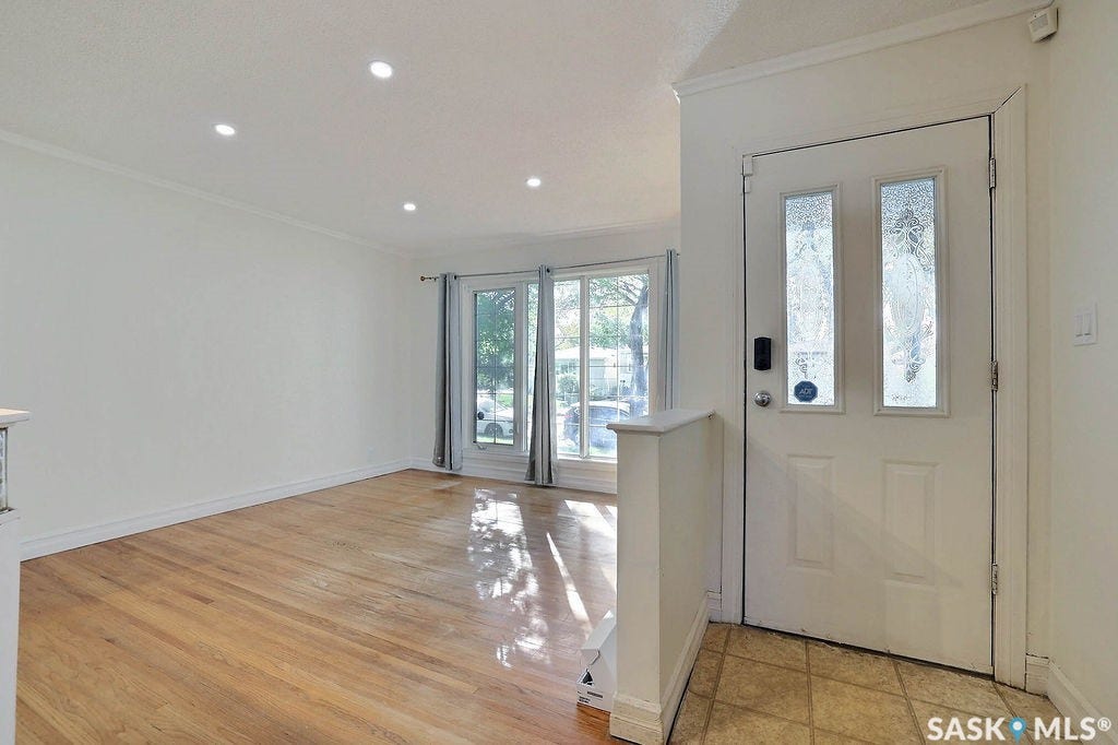 Hardwood flooring, recessed lighting, front door with decorative glass inserts, front windows, crown molding