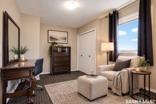 Sophisticated bedroom suite featuring-- AI generated hardwood-finish flooring, a dark wood dresser with ample storage, a full-length framed mirror, and large windows with blackout drapery