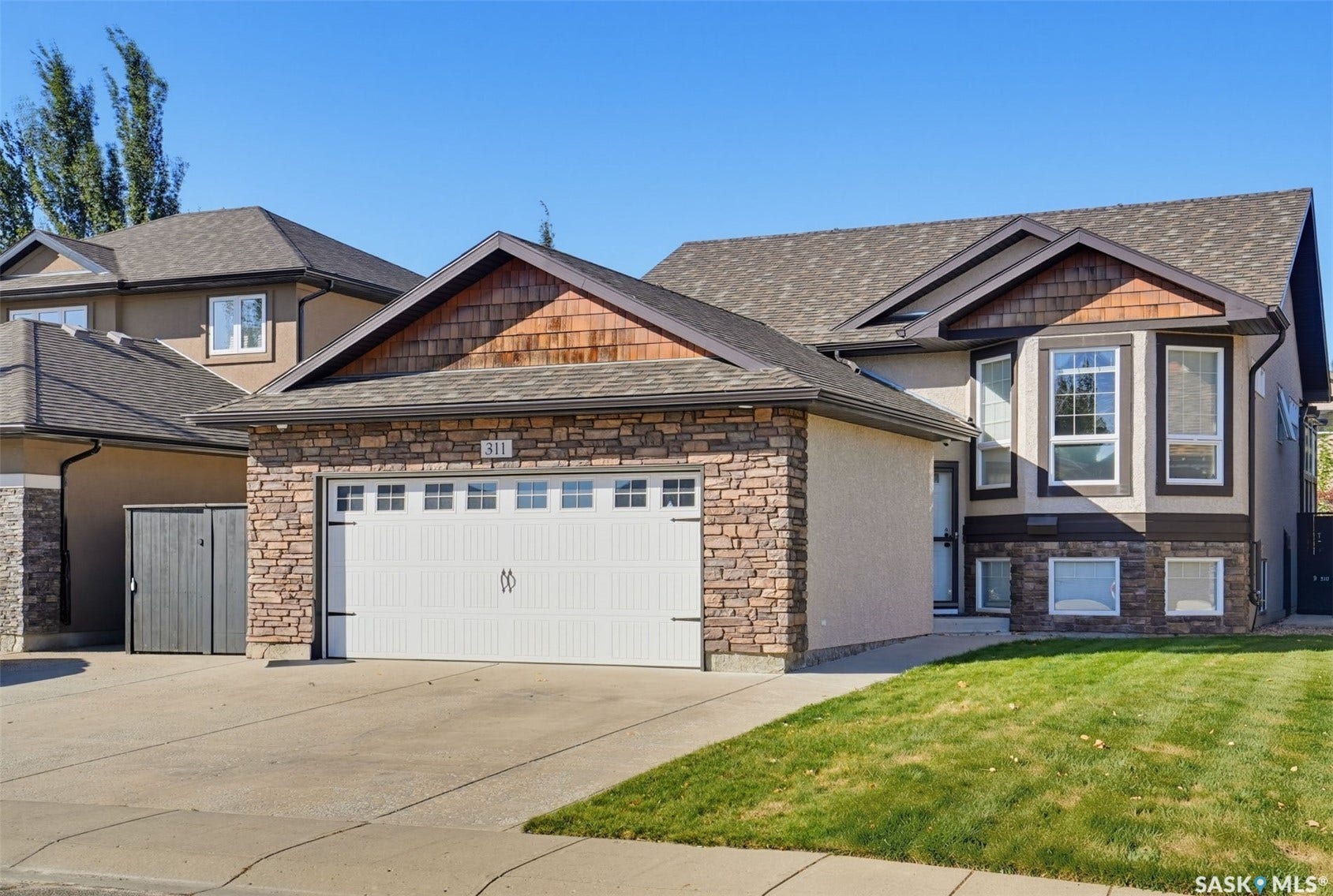 Exterior featuring stone accents, shake siding, and stucco finish