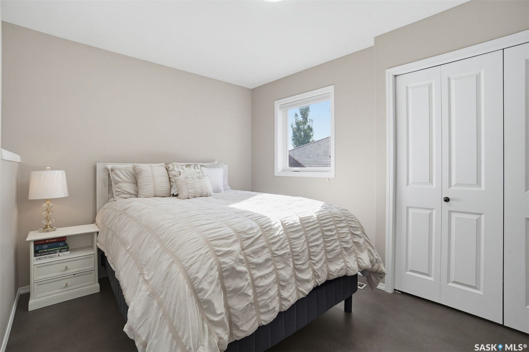 Neutral-toned walls complement the dark wood-finish flooring