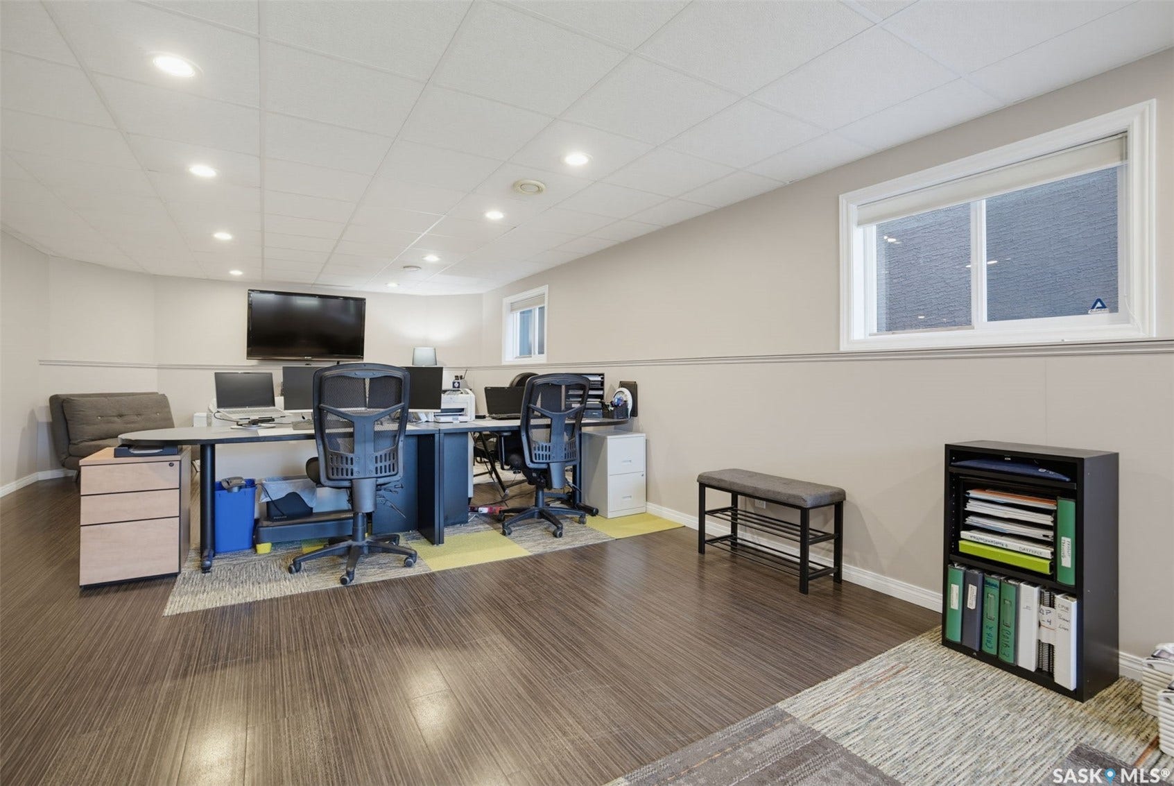 Recessed lighting, wood-finish flooring, drop ceiling, and a prominent window