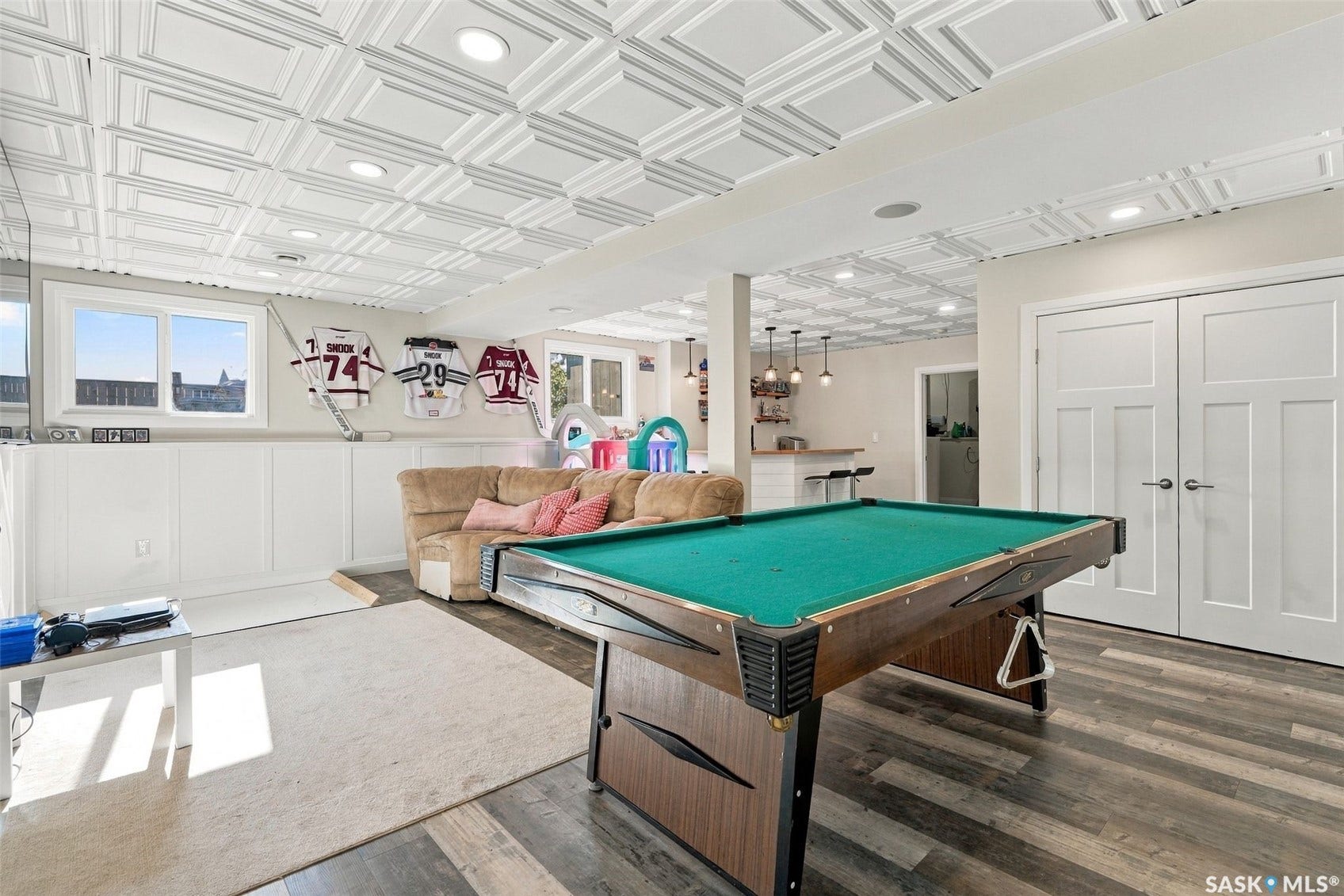Recreational room featuring wood-finish flooring, recessed lighting, and paneling