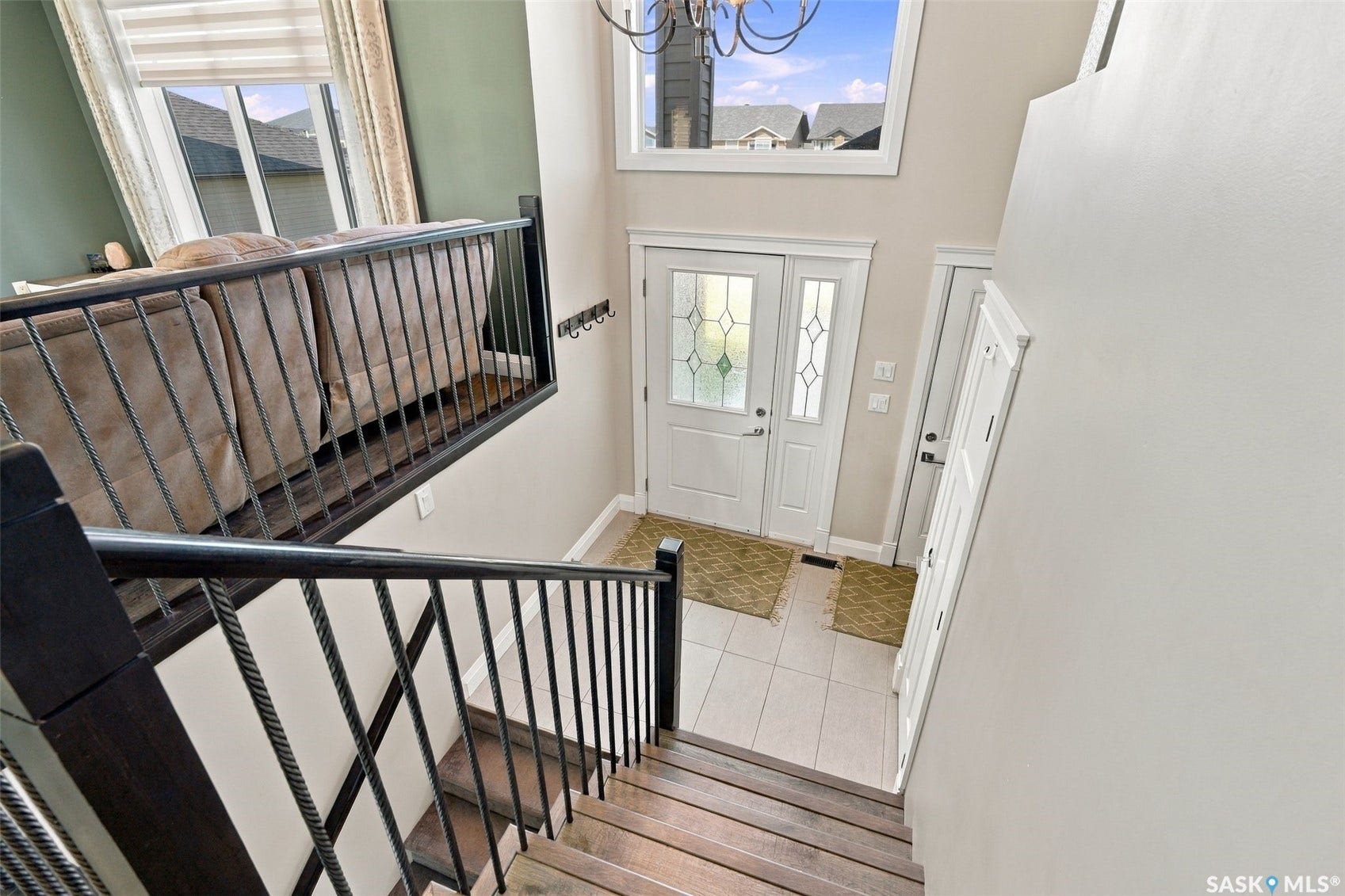 Wood-finish staircase with wrought iron railings