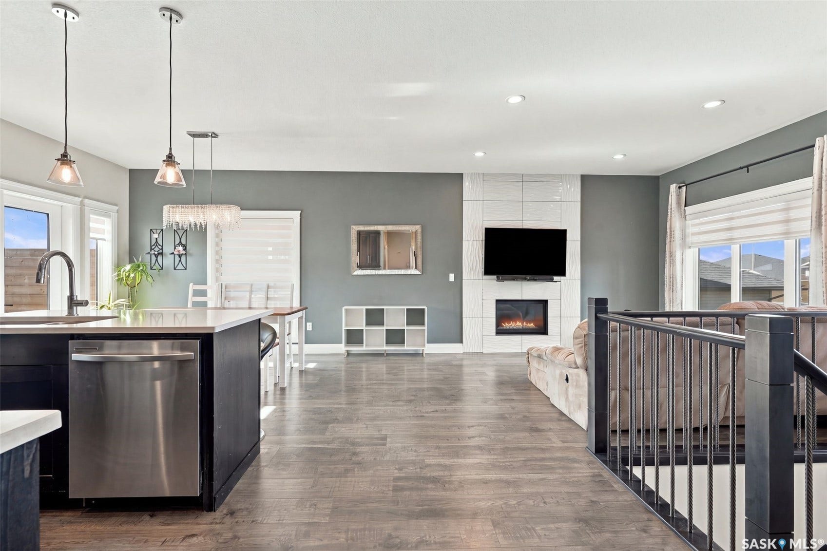 Open-concept living space with wood-finish flooring