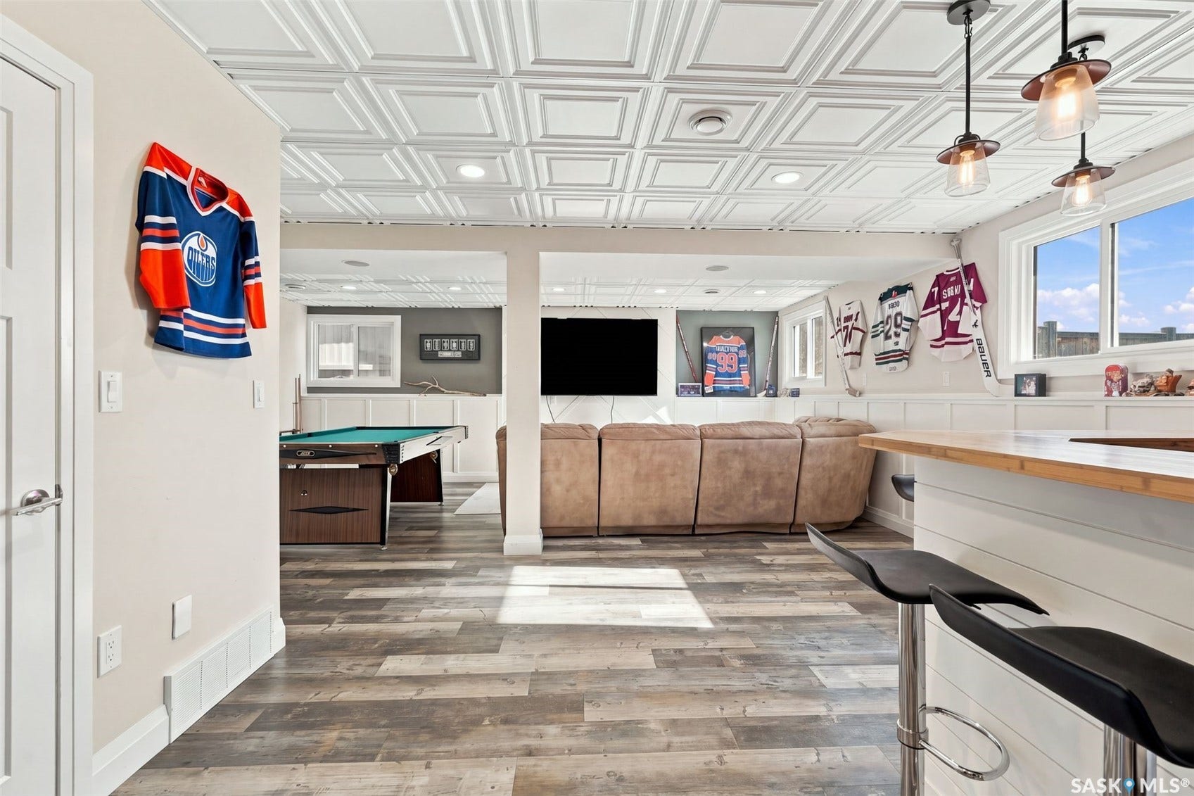 Wood-finish flooring, recessed lighting, and a detailed ceiling
