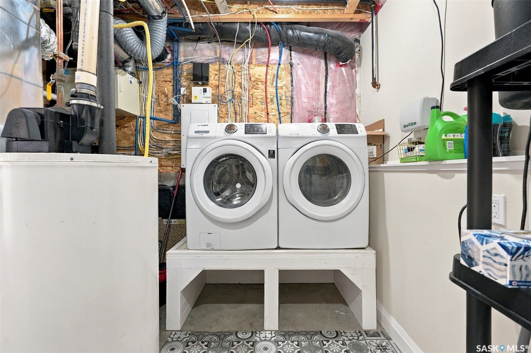 Dedicated laundry area featuring a front-loading washer and dryer set