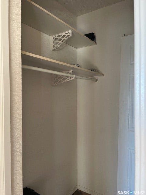 Built-in shelving and hanging rods within a closet space