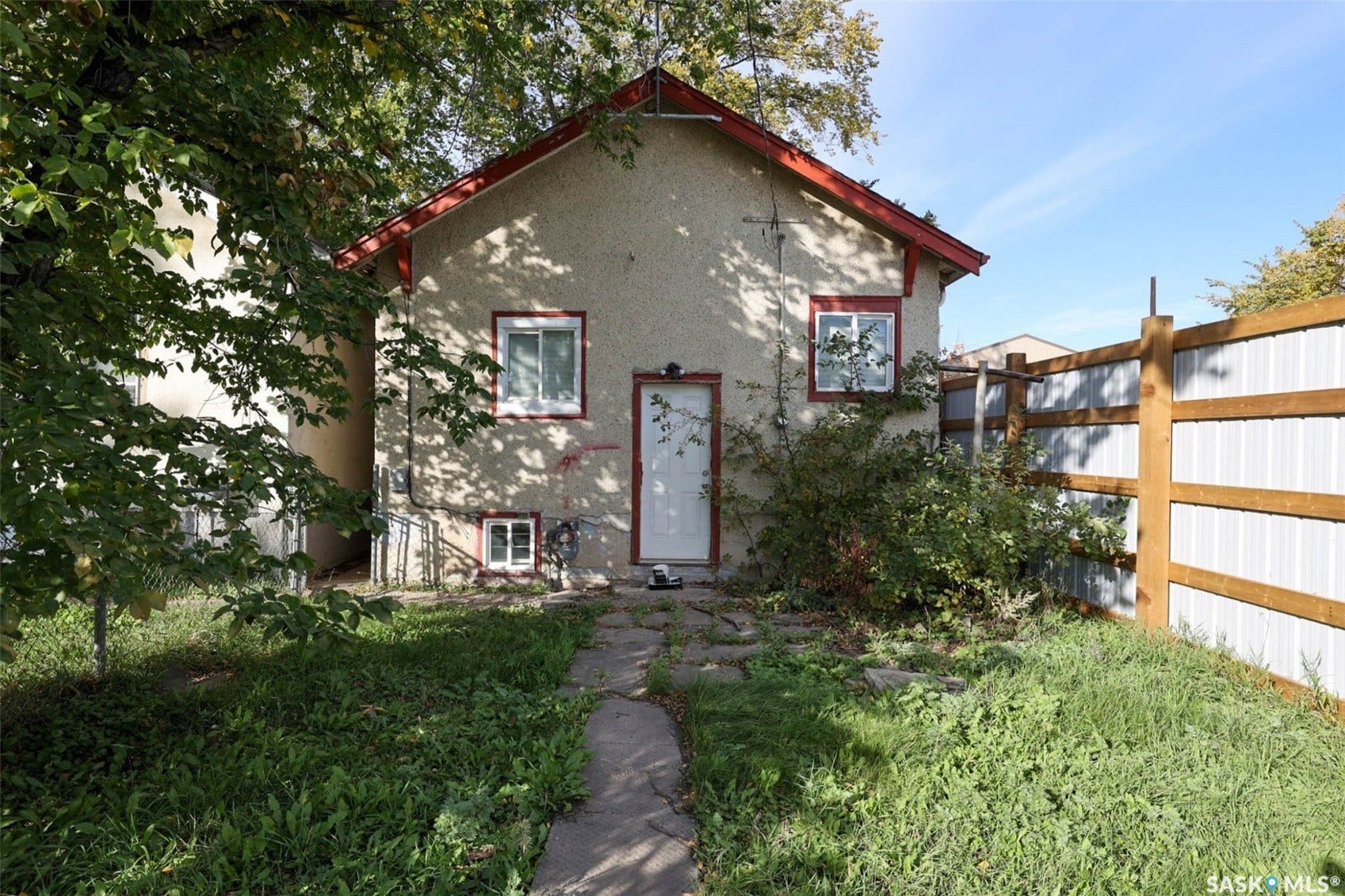 Stucco exterior with red trim accents