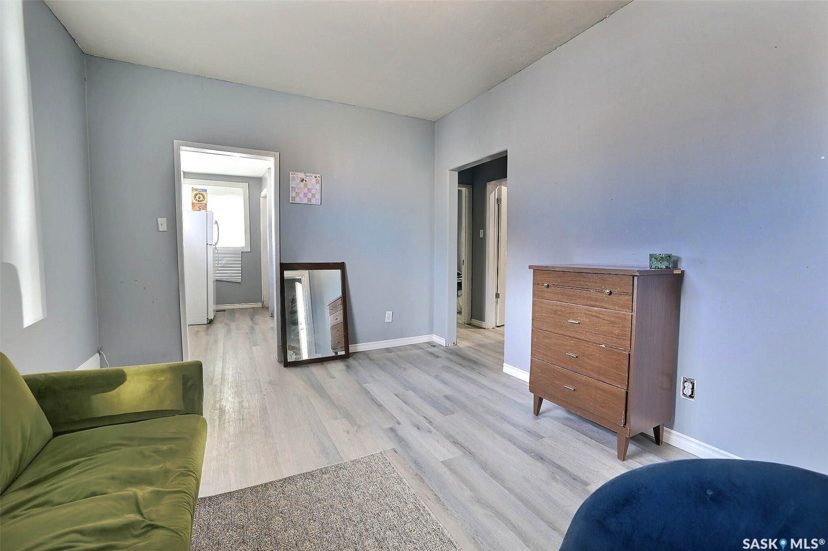 Light gray walls complement the wood-finish flooring throughout the space