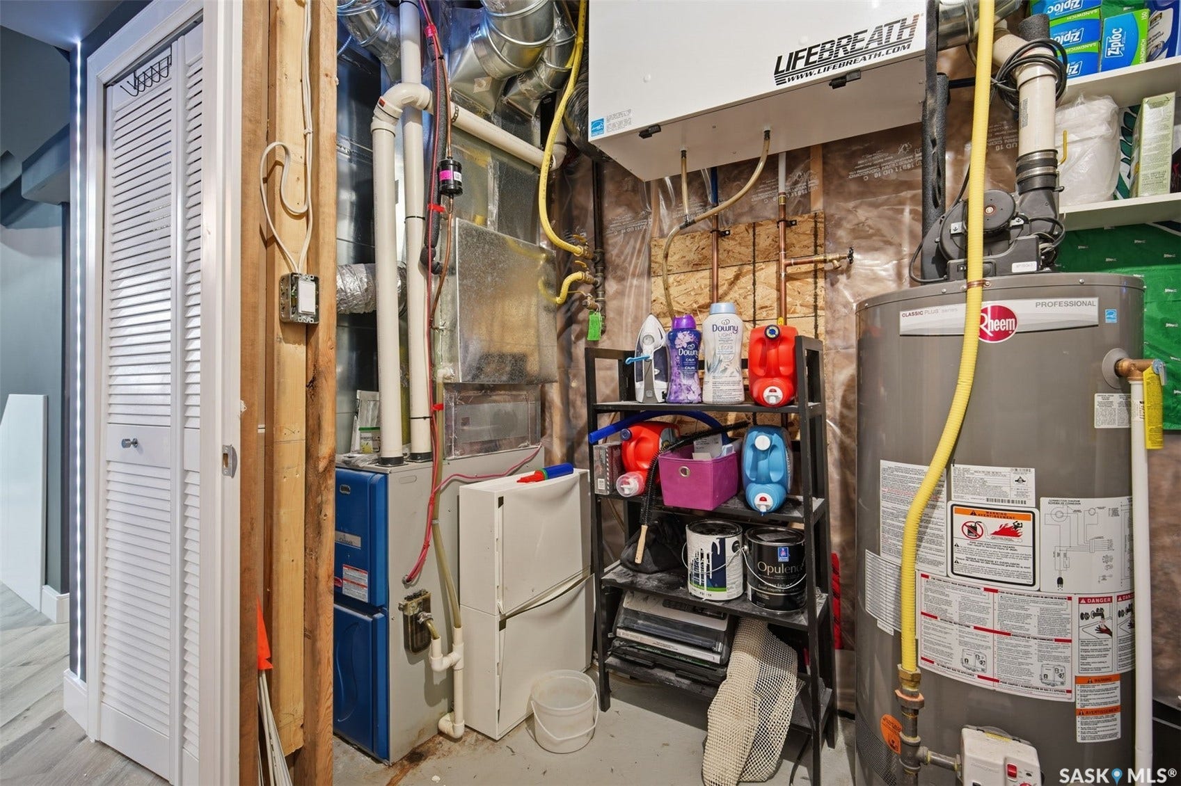 Utility area featuring a water heater, furnace, and ventilation system