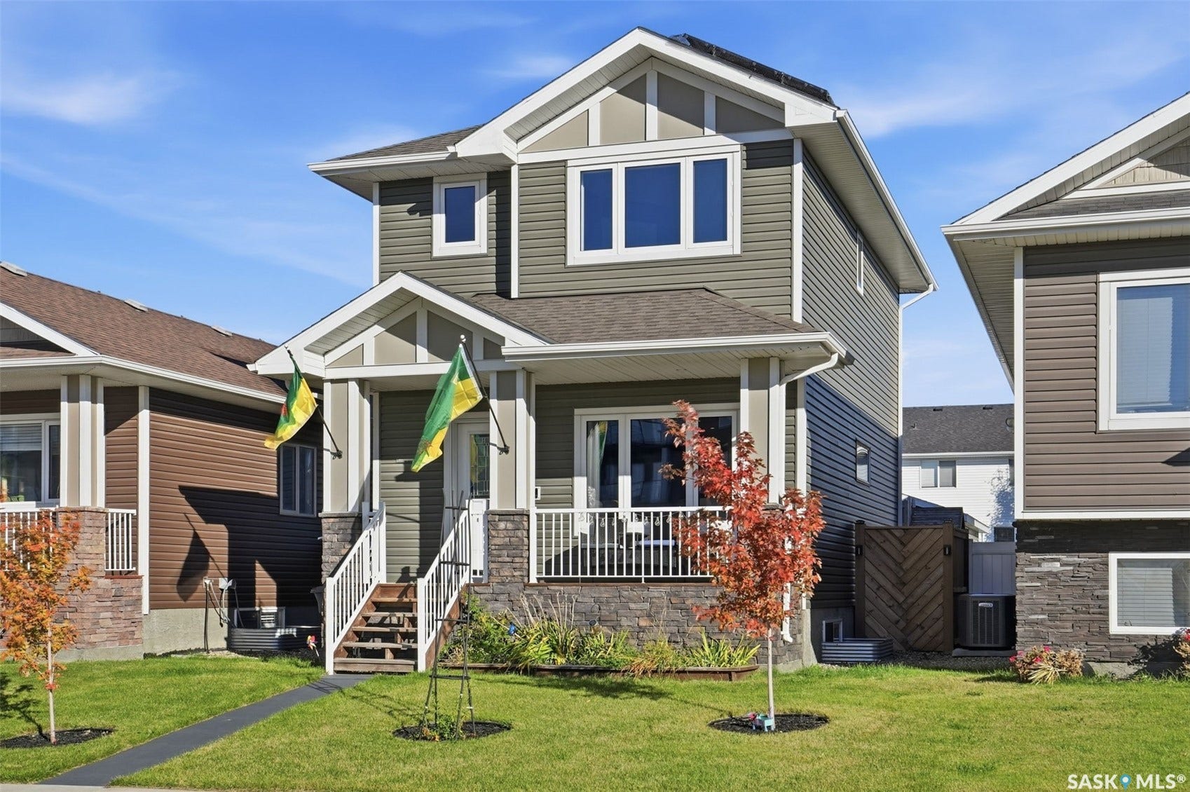 Two-story exterior with multi-toned siding and stone accents