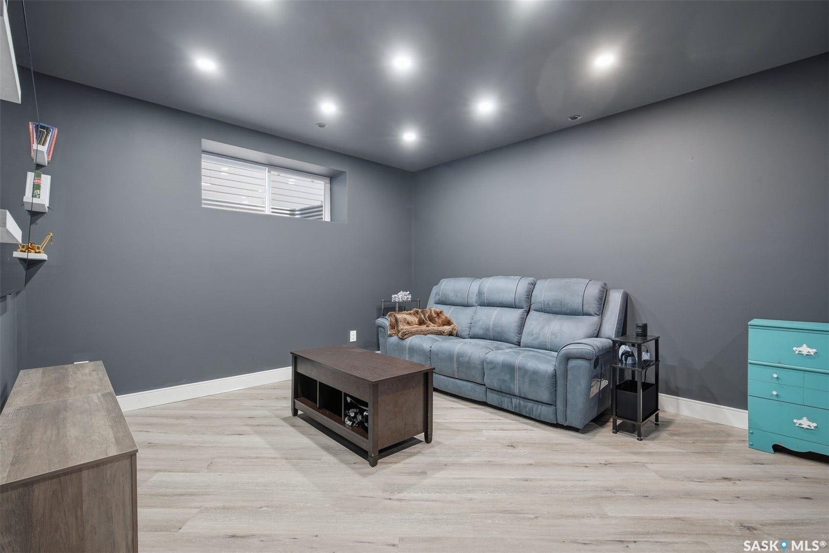 Recessed lighting, light wood-finish flooring, and a window with blinds