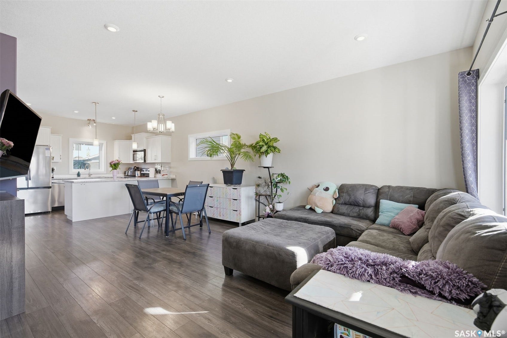 Open-concept living space featuring wood-finish flooring and recessed lighting