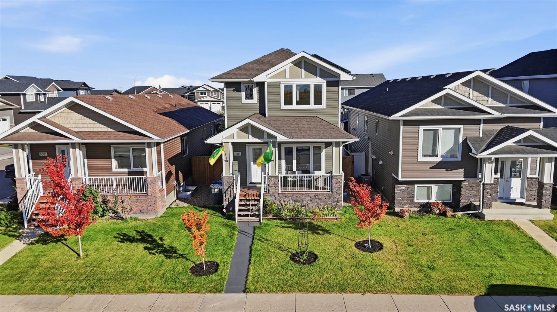 Front exterior featuring a covered porch, stone accents, siding, and a shingled roof