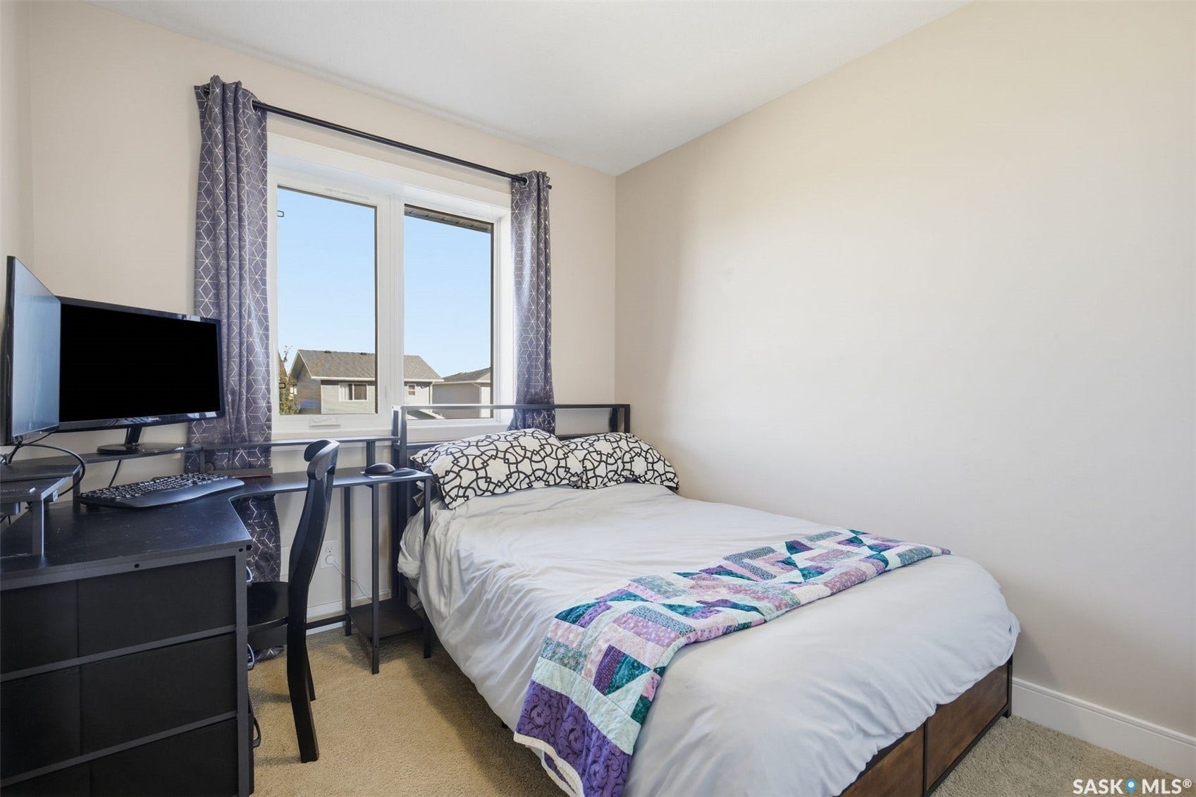 Carpeted flooring, painted walls, white trim, and a double-pane window