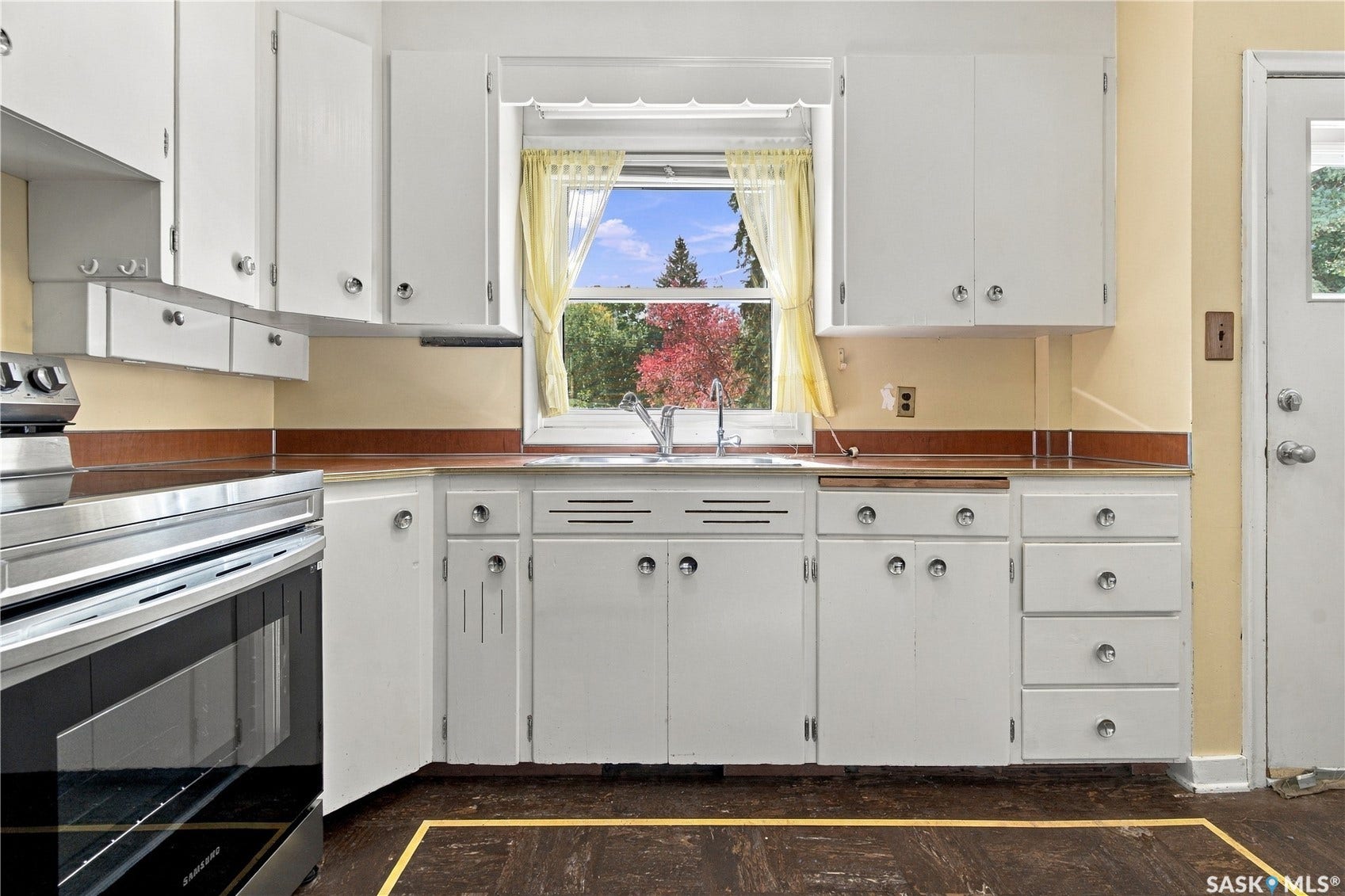 2727 Assiniboine Avenue, Regina SK S4S 1C7 Kitchen featuring white cabinetry, a stainless steel range, and wood-finish countertops