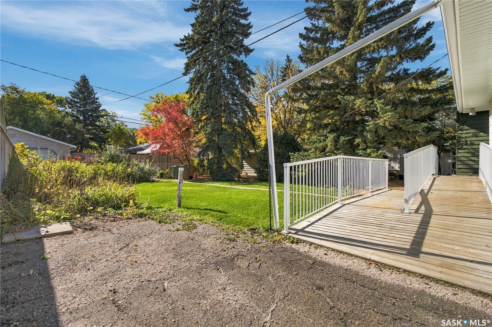 2727 Assiniboine Avenue, Regina SK S4S 1C7 Wood-finish deck with white metal railing and a ramp entry