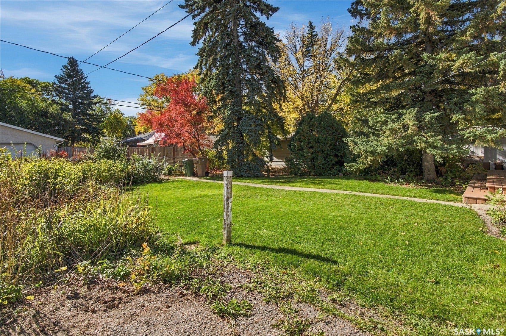 2727 Assiniboine Avenue, Regina SK S4S 1C7 Manicured lawn with a concrete pathway and mature trees