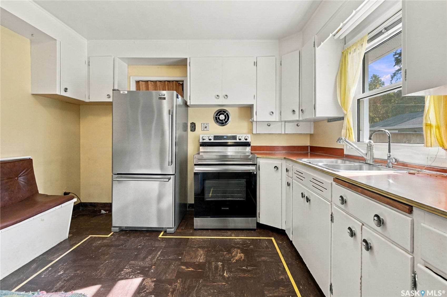 2727 Assiniboine Avenue, Regina SK S4S 1C7 Kitchen featuring white cabinetry, stainless steel appliances, a stainless steel sink, and a window