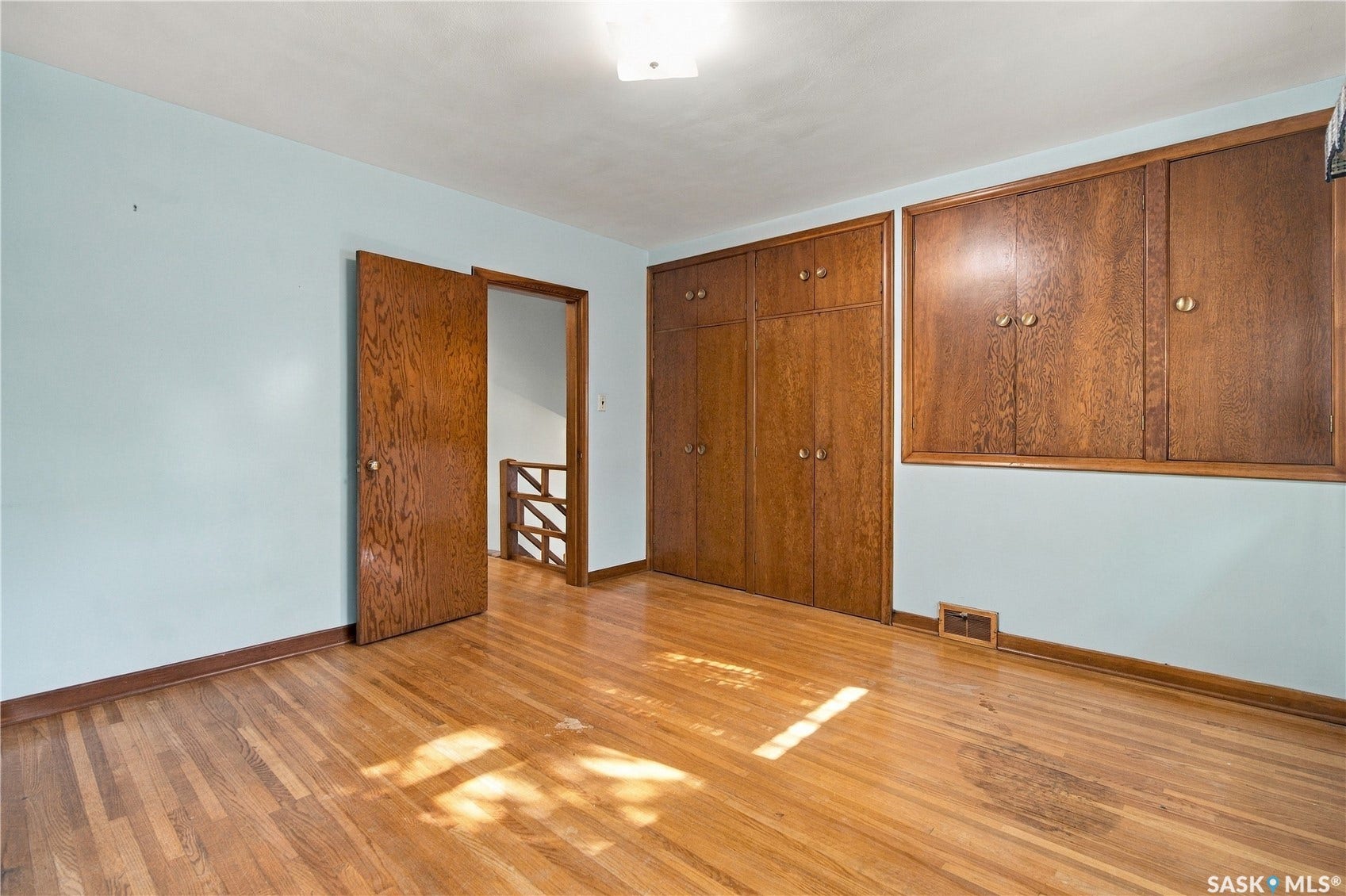 2727 Assiniboine Avenue, Regina SK S4S 1C7 Hardwood flooring, wood-finish built-in cabinetry, and wood-finish doors