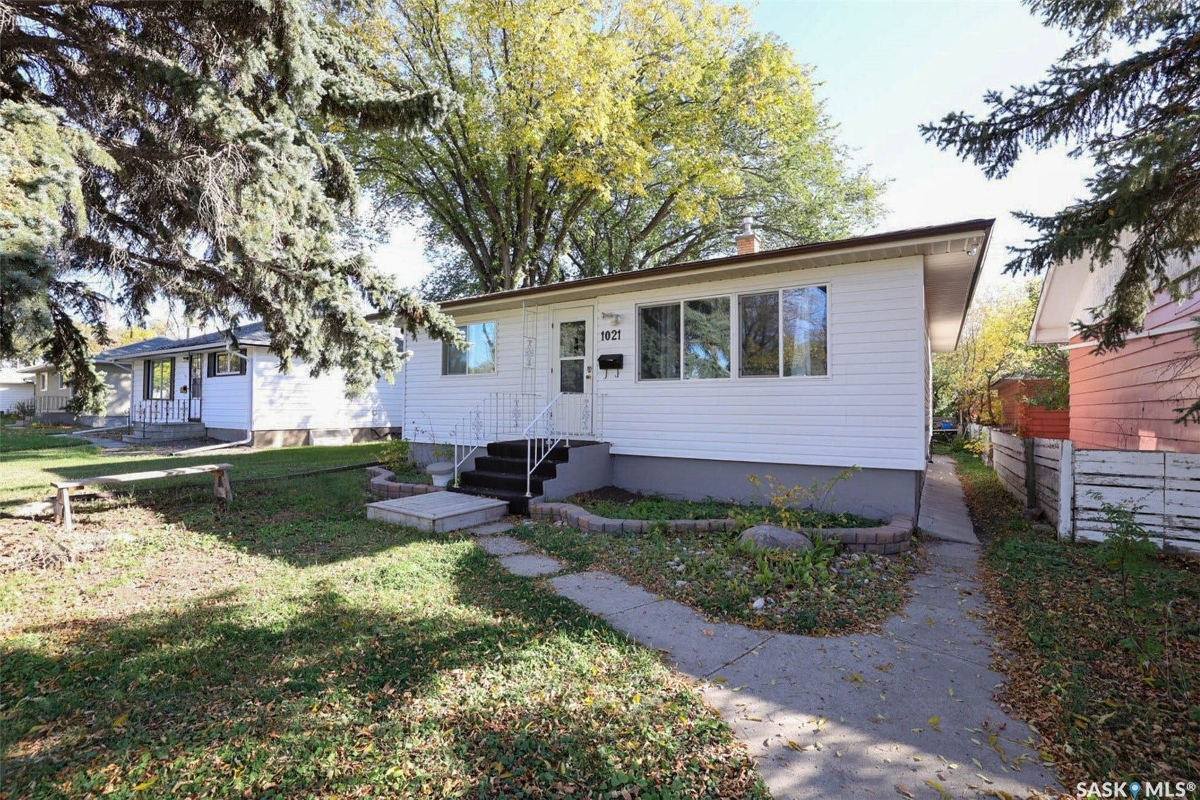 1021 Campbell Street, Regina SK S4T 5P5 White siding exterior with a dark trim roofline