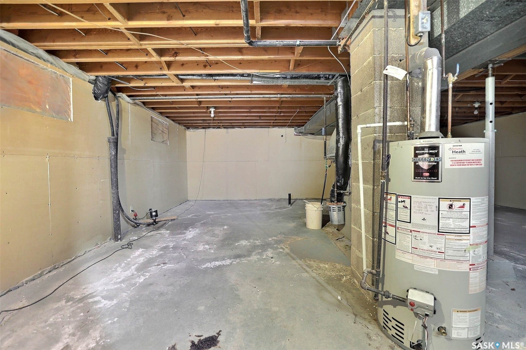 1021 Campbell Street, Regina SK S4T 5P5 Exposed ceiling joists and concrete flooring with a water heater and visible plumbing