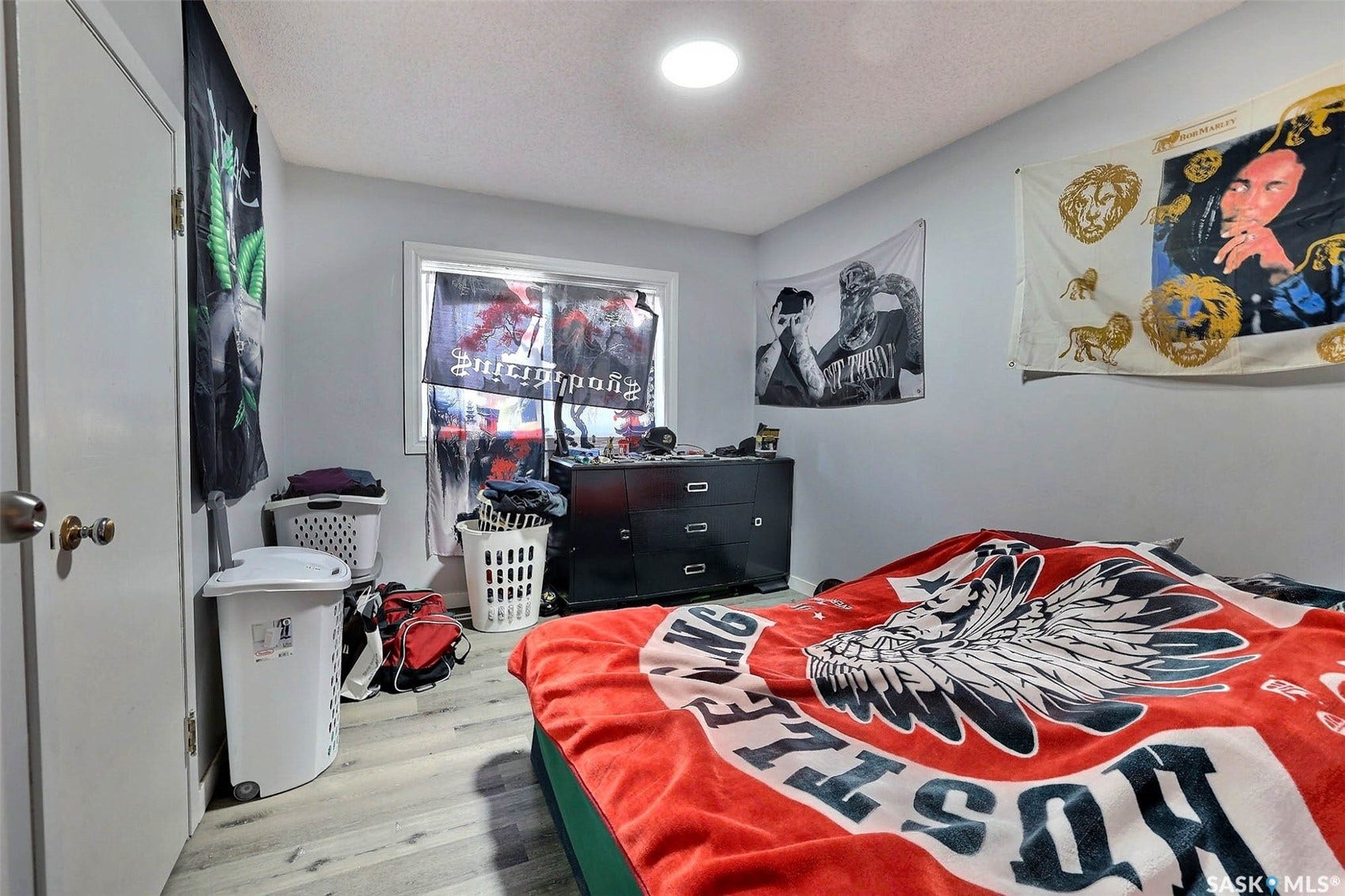 1021 Campbell Street, Regina SK S4T 5P5 Recessed ceiling lighting, light gray wall paint, wood-finish flooring, white trim window, and a white interior door