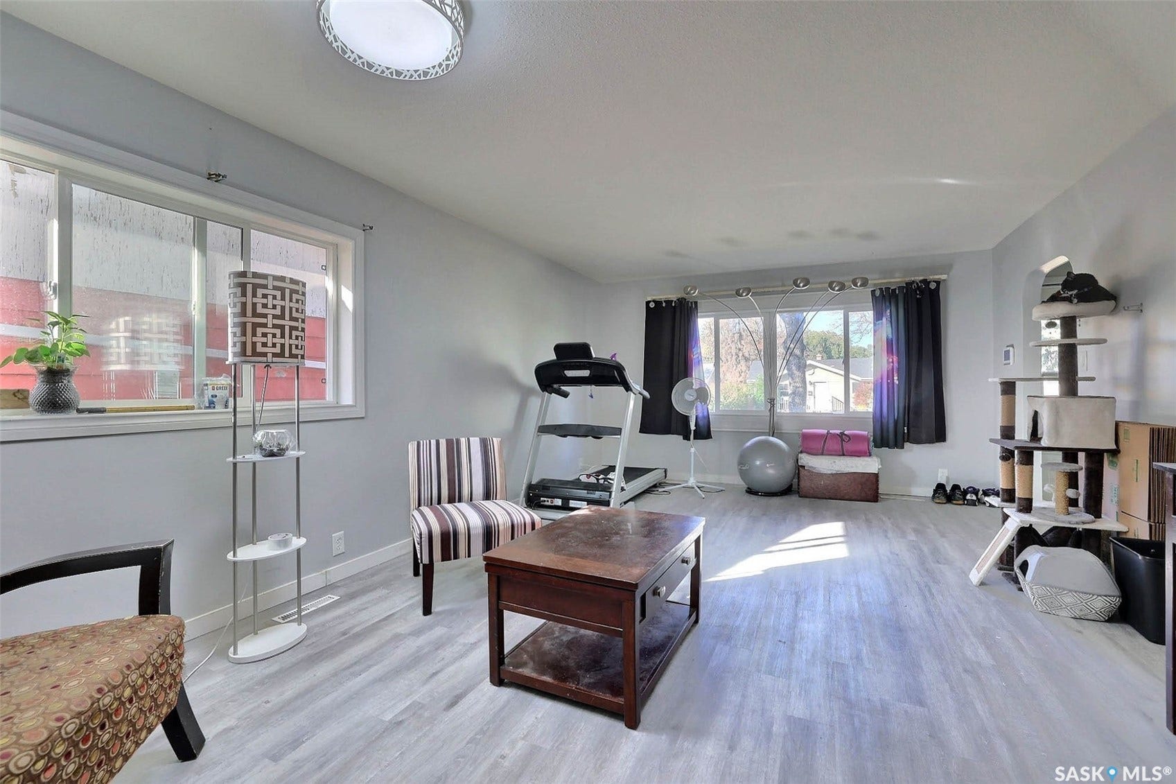 1021 Campbell Street, Regina SK S4T 5P5 Spacious interior with light gray walls, light wood-finish flooring, and multiple windows