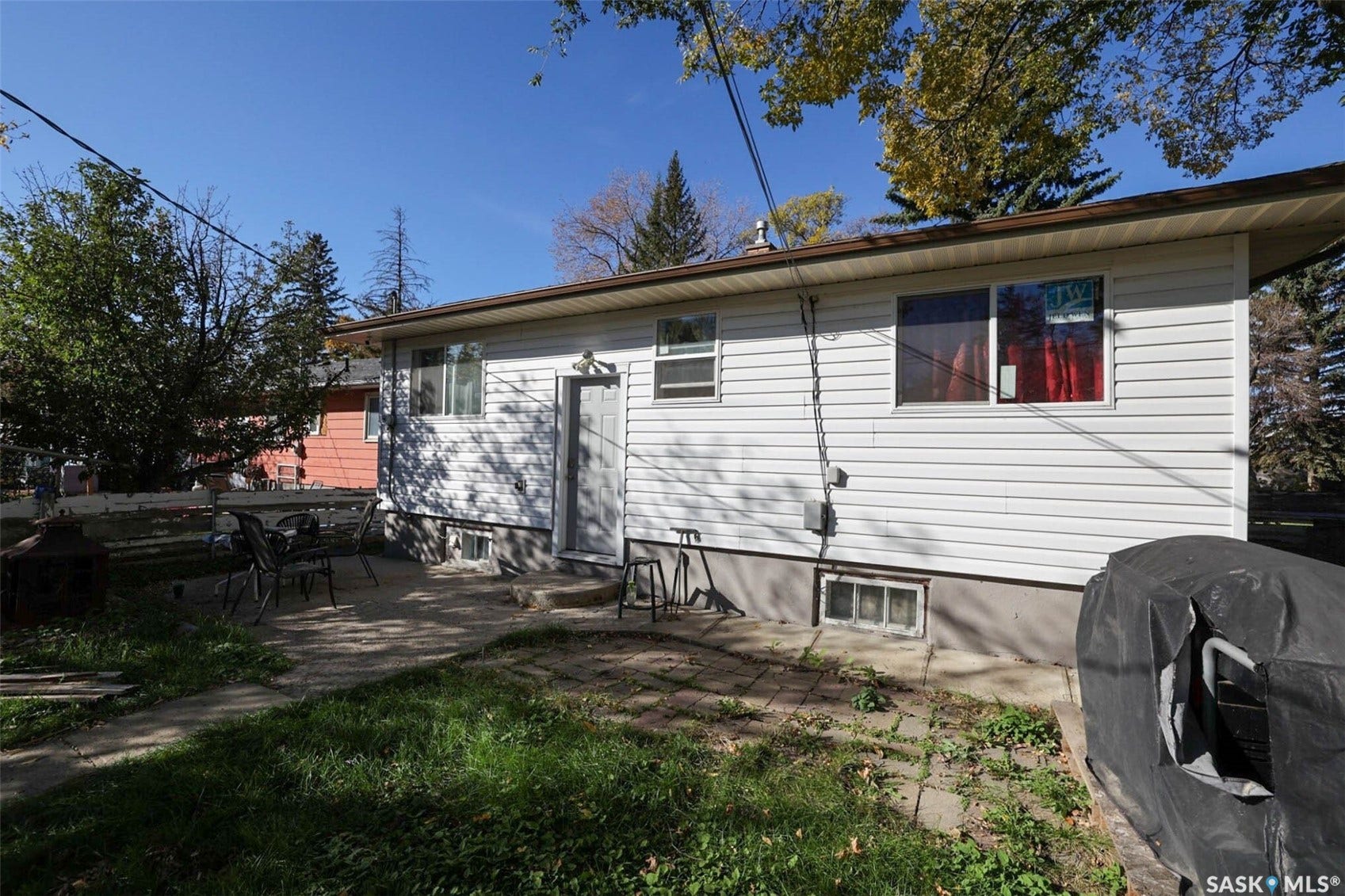 1021 Campbell Street, Regina SK S4T 5P5 White horizontal siding exterior with a concrete foundation and brown eaves
