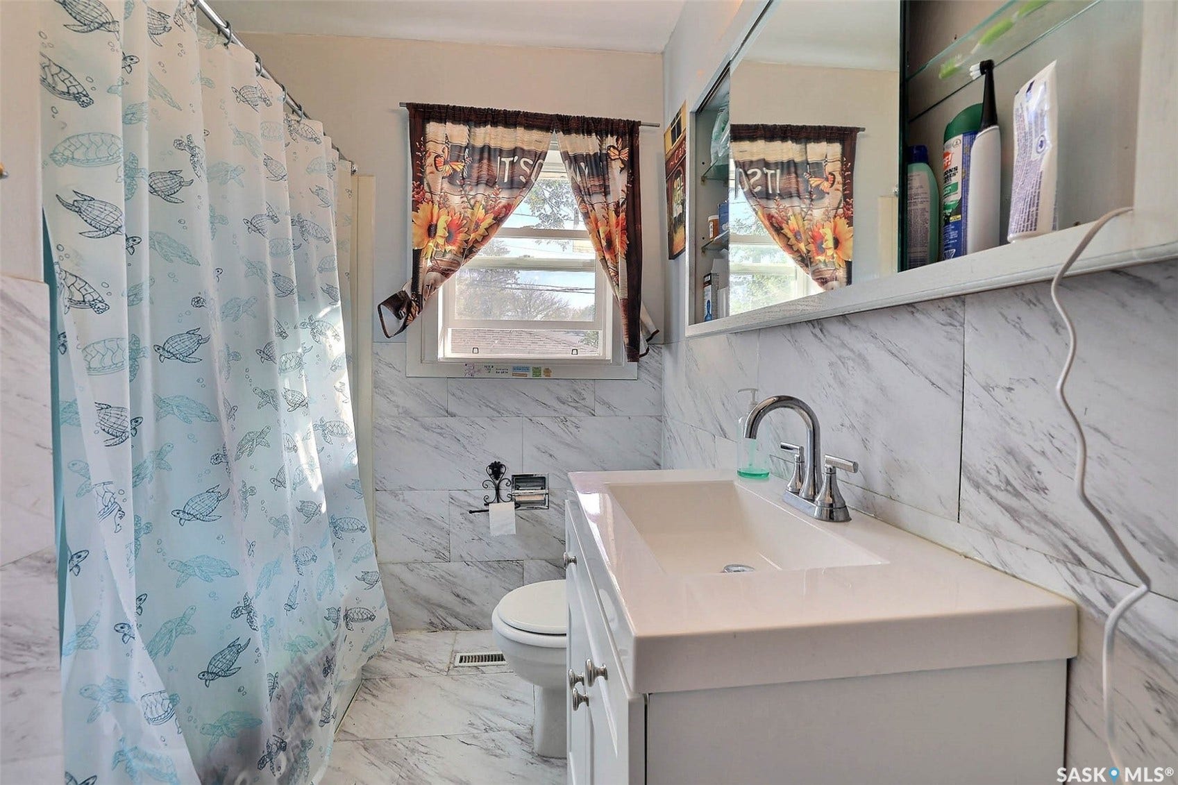 1021 Campbell Street, Regina SK S4T 5P5 White vanity with an integrated rectangular sink and chrome faucet