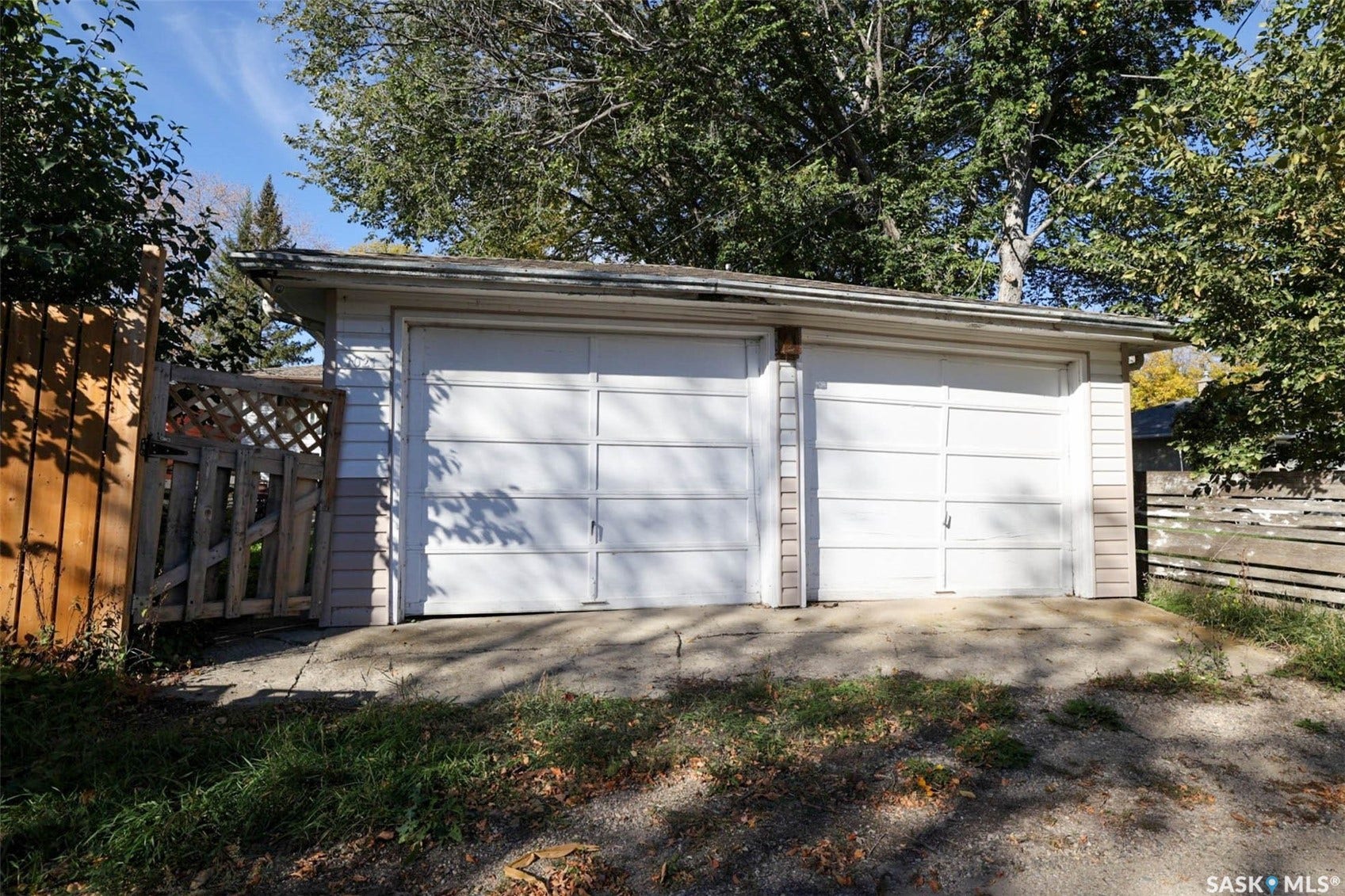 1021 Campbell Street, Regina SK S4T 5P5 Two-car garage with white panel doors and light-colored siding