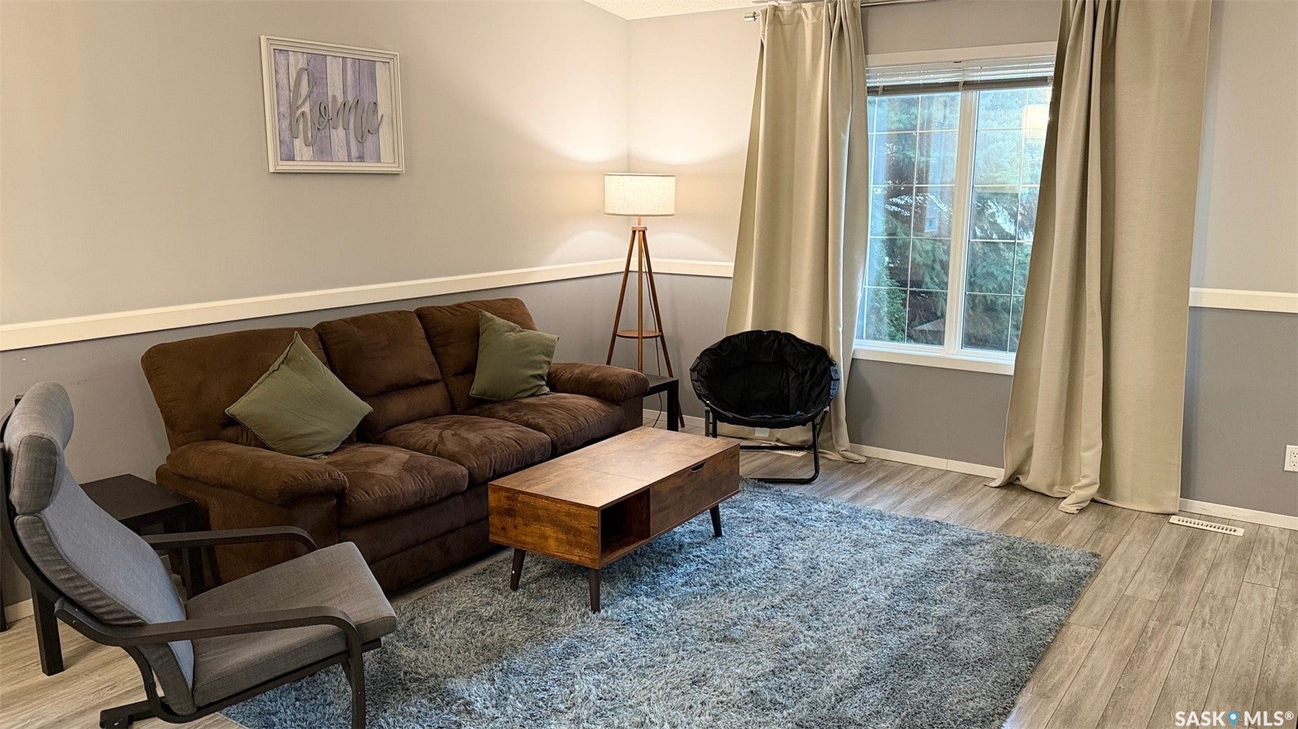 Wood-finish flooring throughout, complemented by a chair rail molding