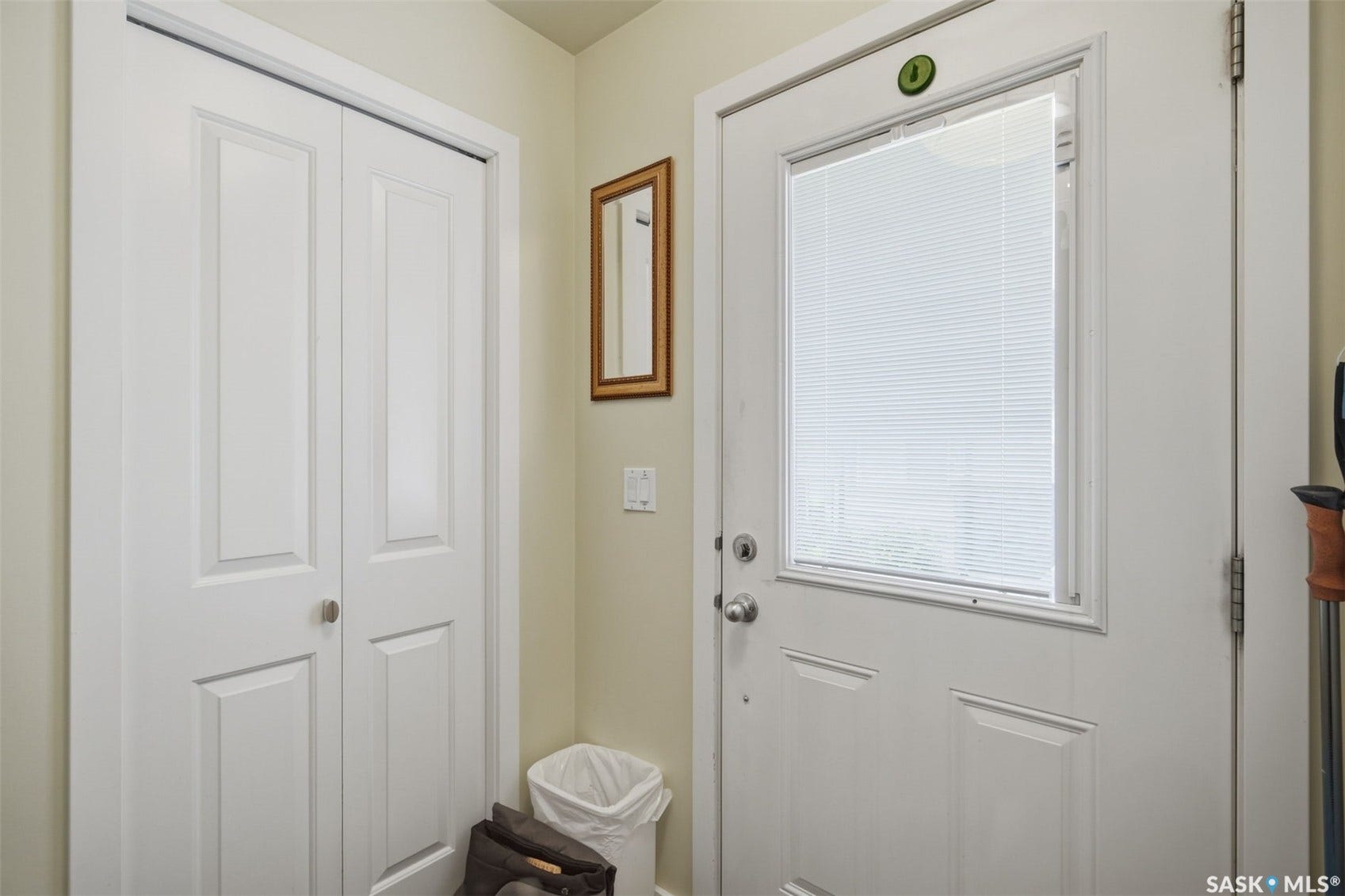 White paneled entry door with integrated blinds