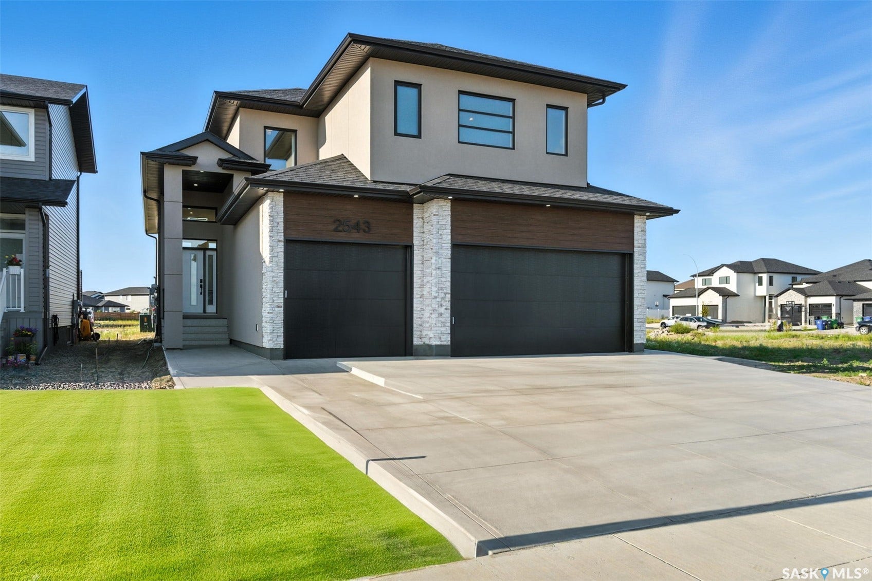 Contemporary exterior with stucco and stone veneer accents