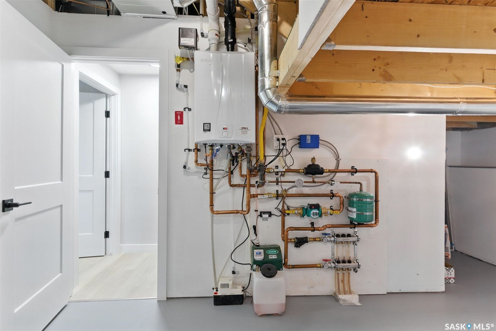 Tankless water heater system with copper piping and exposed wooden beams