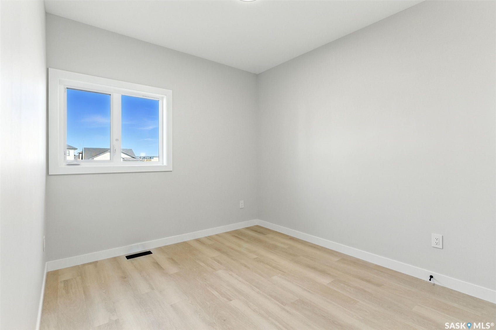 Recessed ceiling lighting, light wood-finish flooring, white trim, and a double-pane window