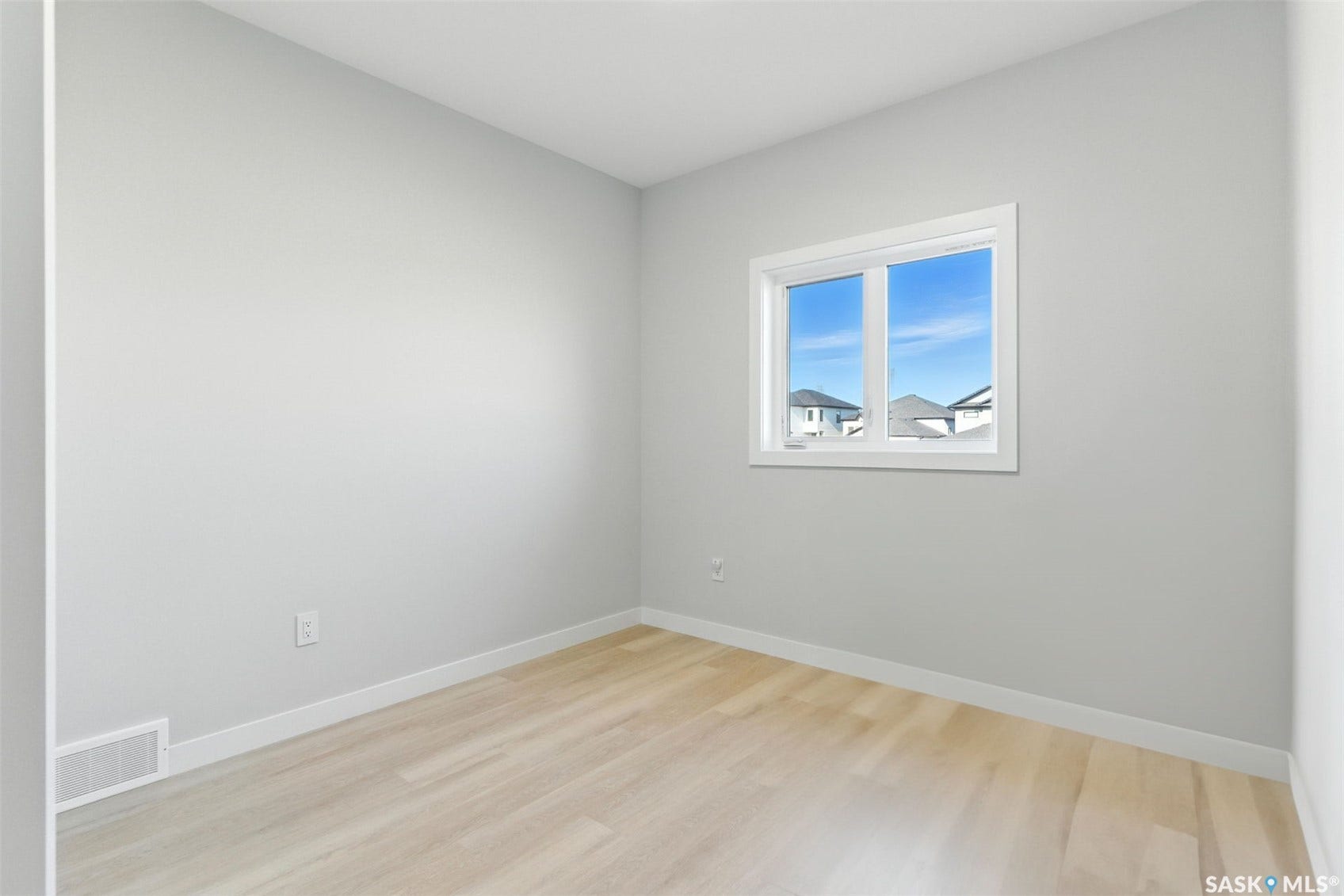 Bright interior with light-toned walls, wood-finish flooring, and white trim