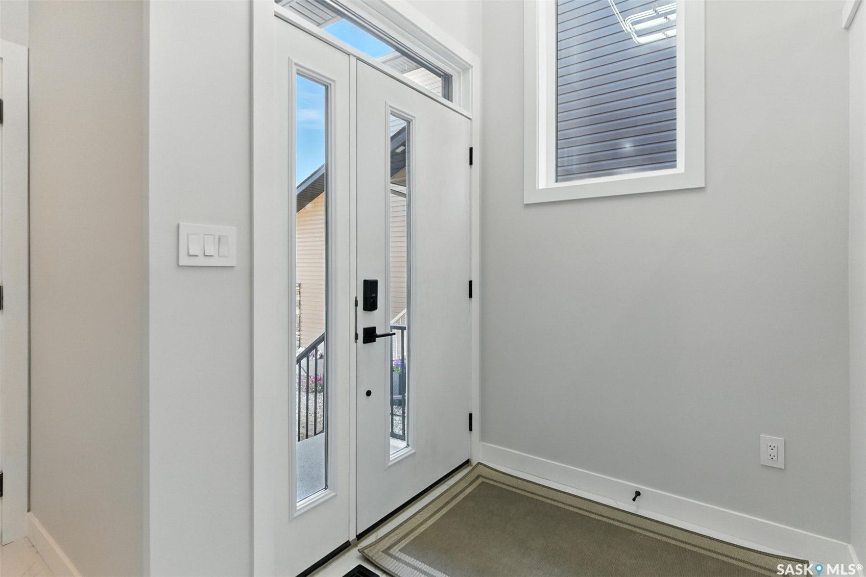 Double entry doors with full-length glass inserts and transom