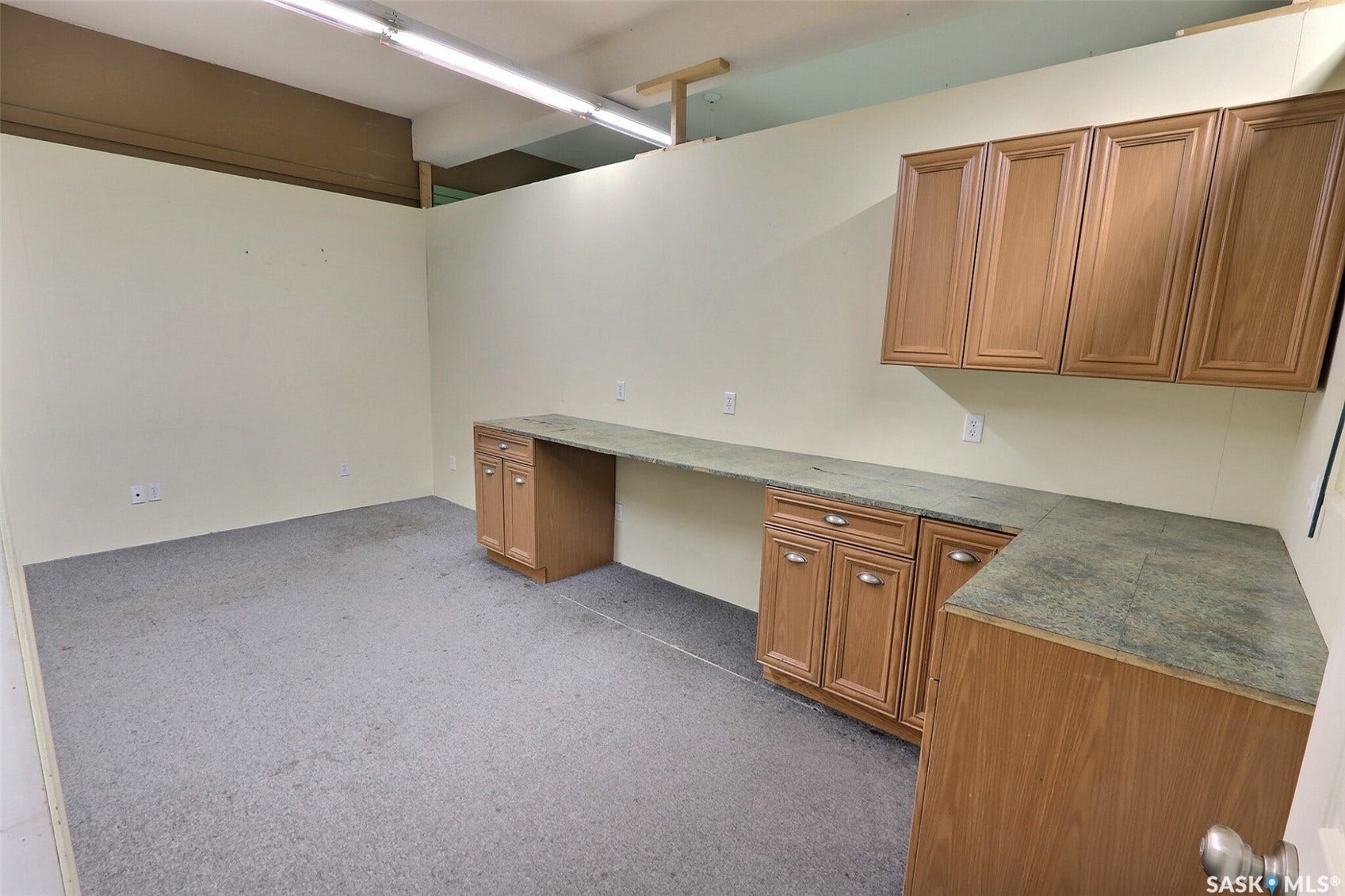 Built-in cabinetry with wood-finish doors, durable countertops, and task lighting