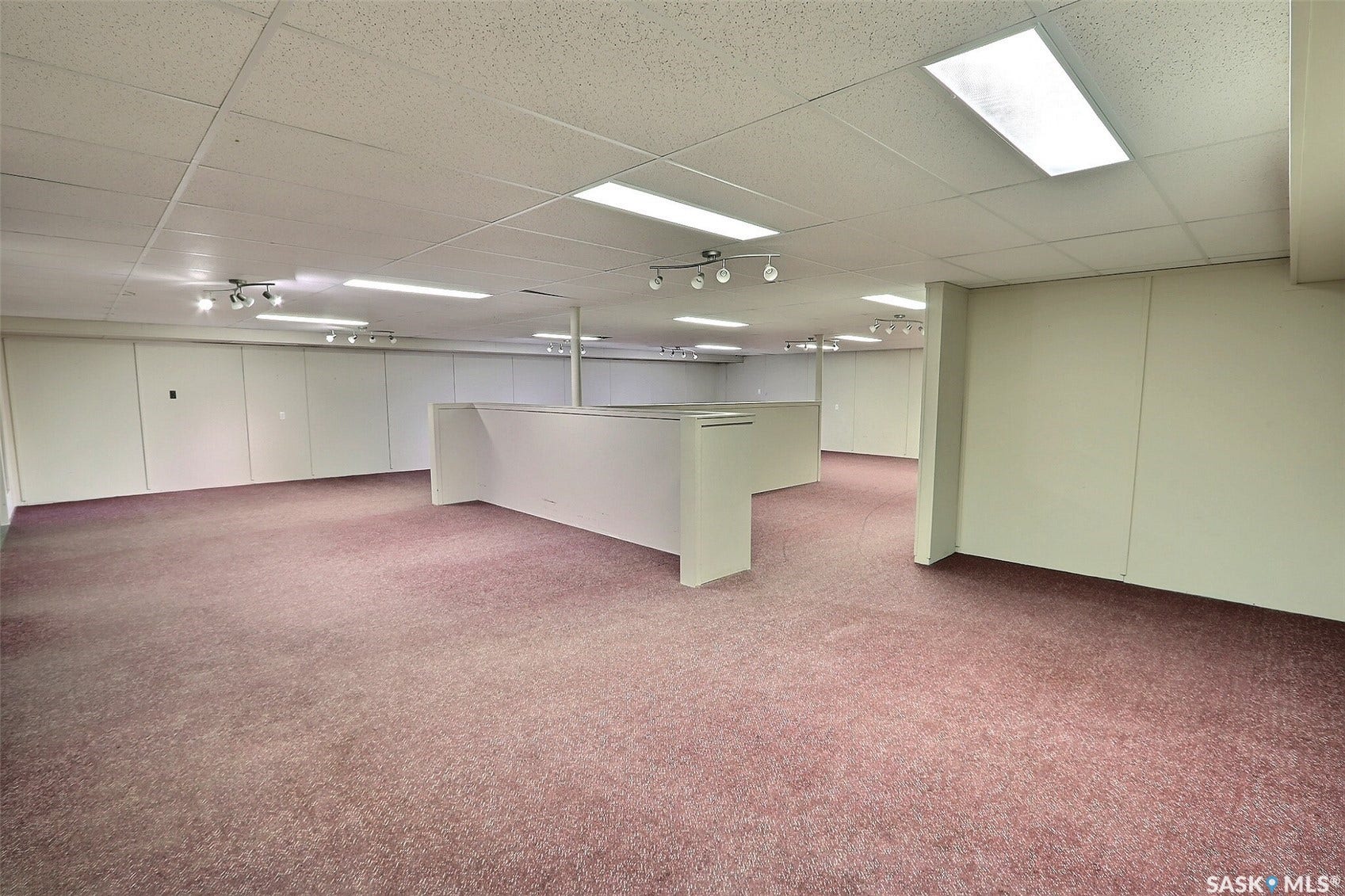 Expansive open-concept room featuring track lighting and recessed lighting