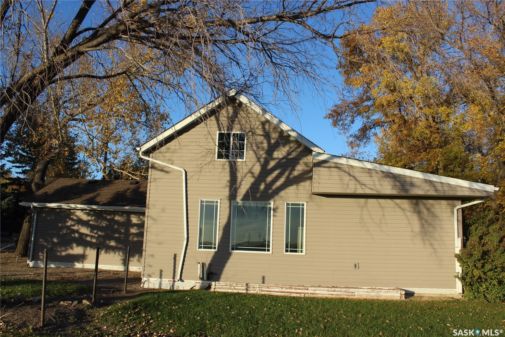 Taupe horizontal siding with white trim