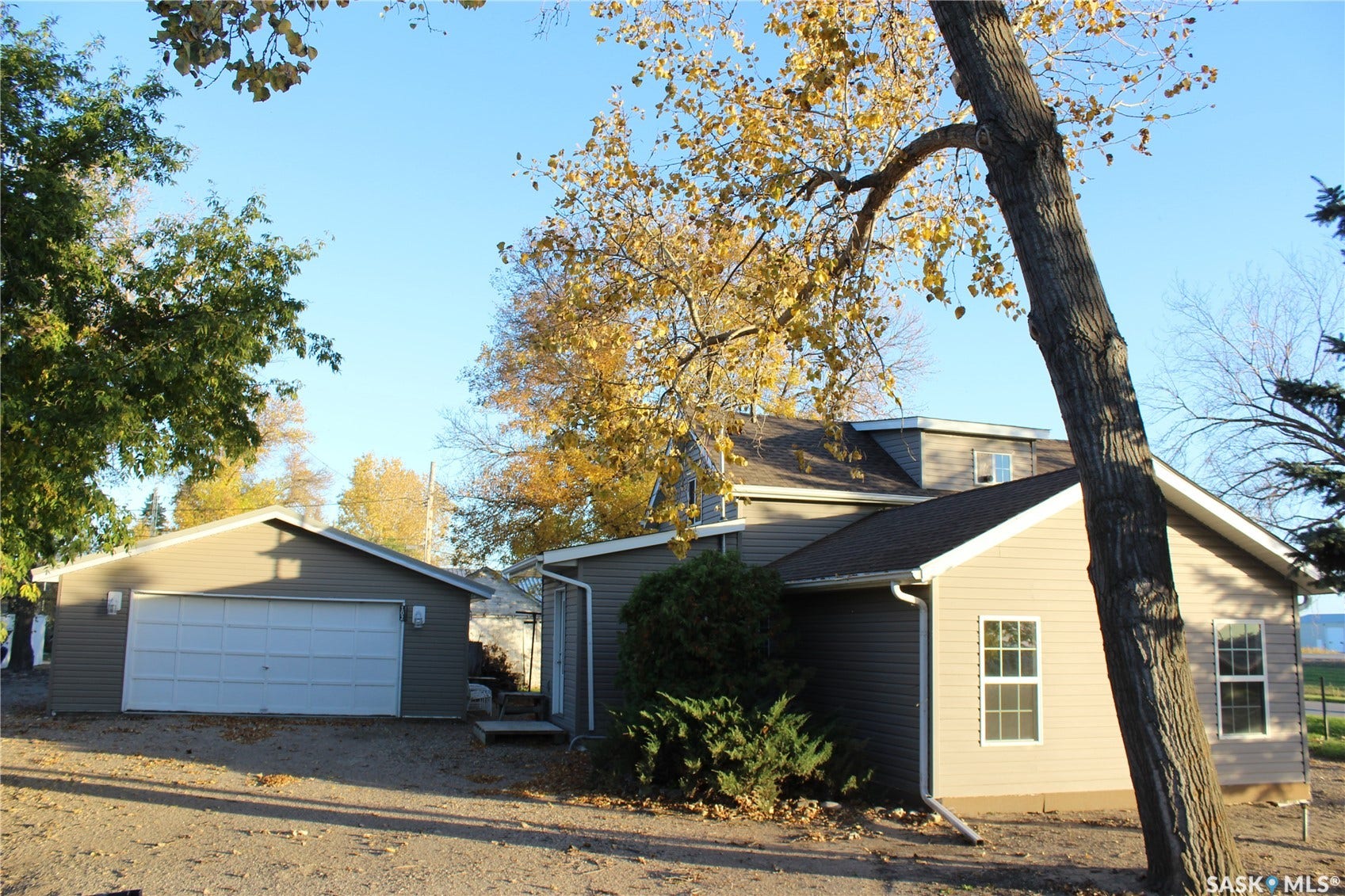 Exterior featuring siding, a detached garage, and dual-pane windows