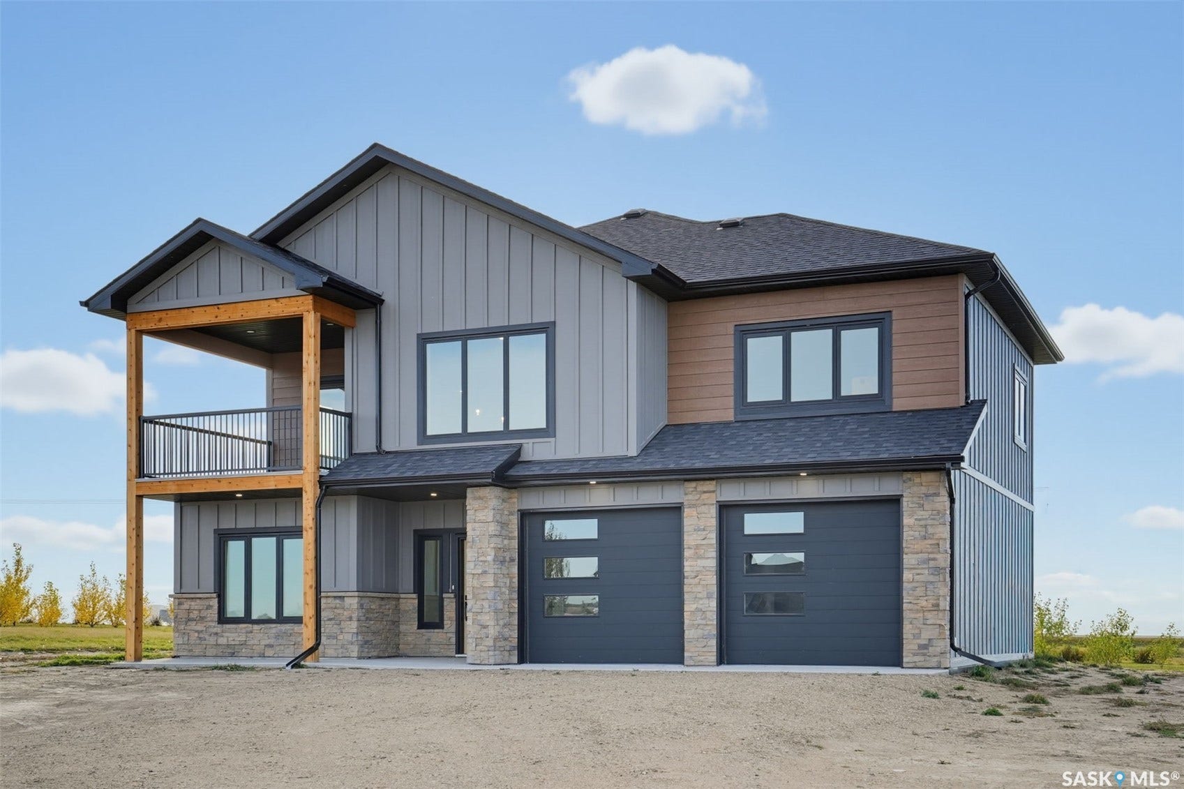 Two-story exterior with vertical siding and stone accents