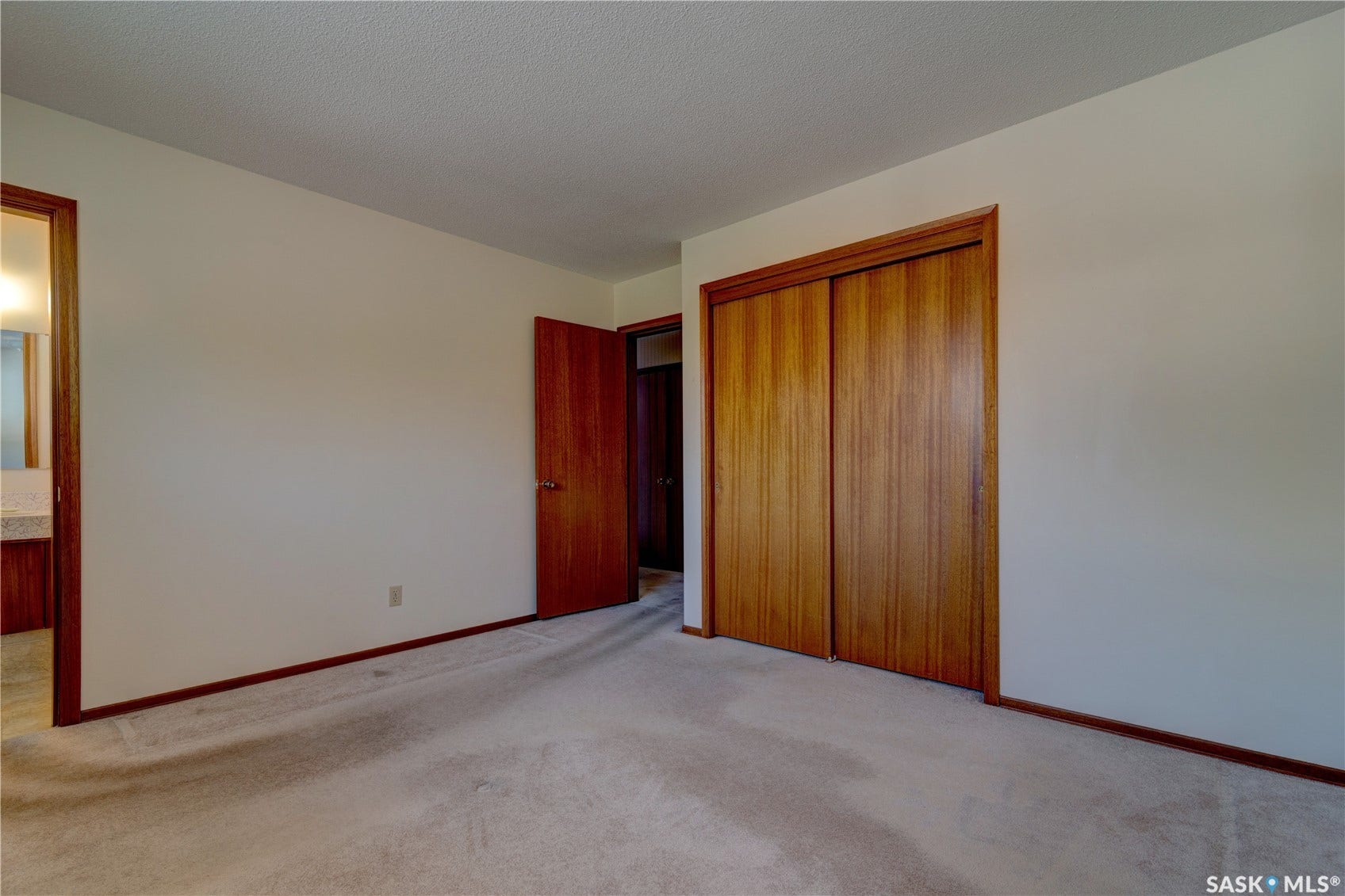 Carpeted flooring with wood-finish trim and doors