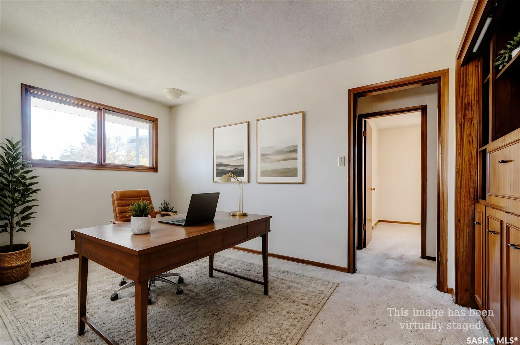 Carpeted flooring, white walls, and a warm wood-finished window frame
