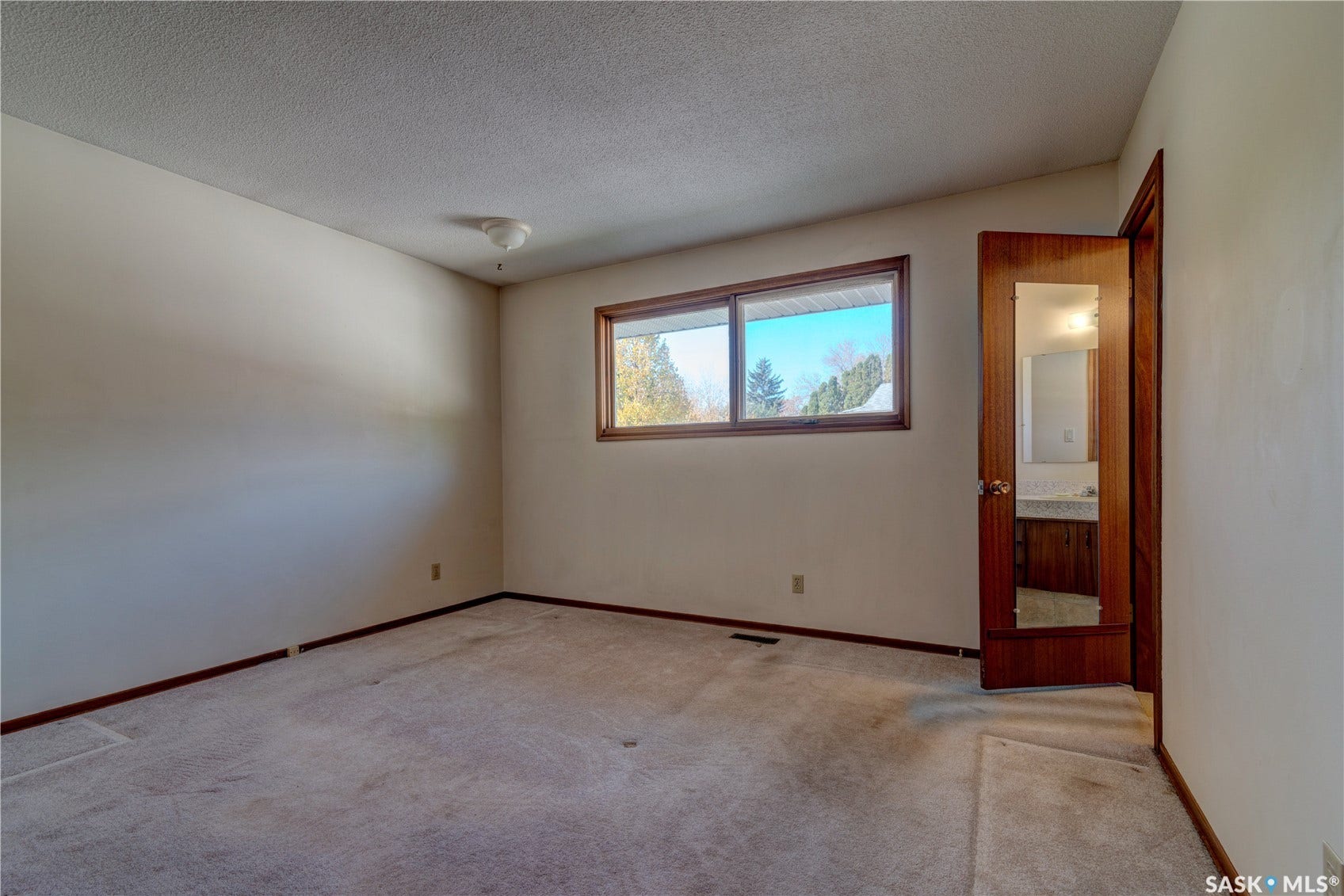Neutral wall color with a contrasting baseboard trim
