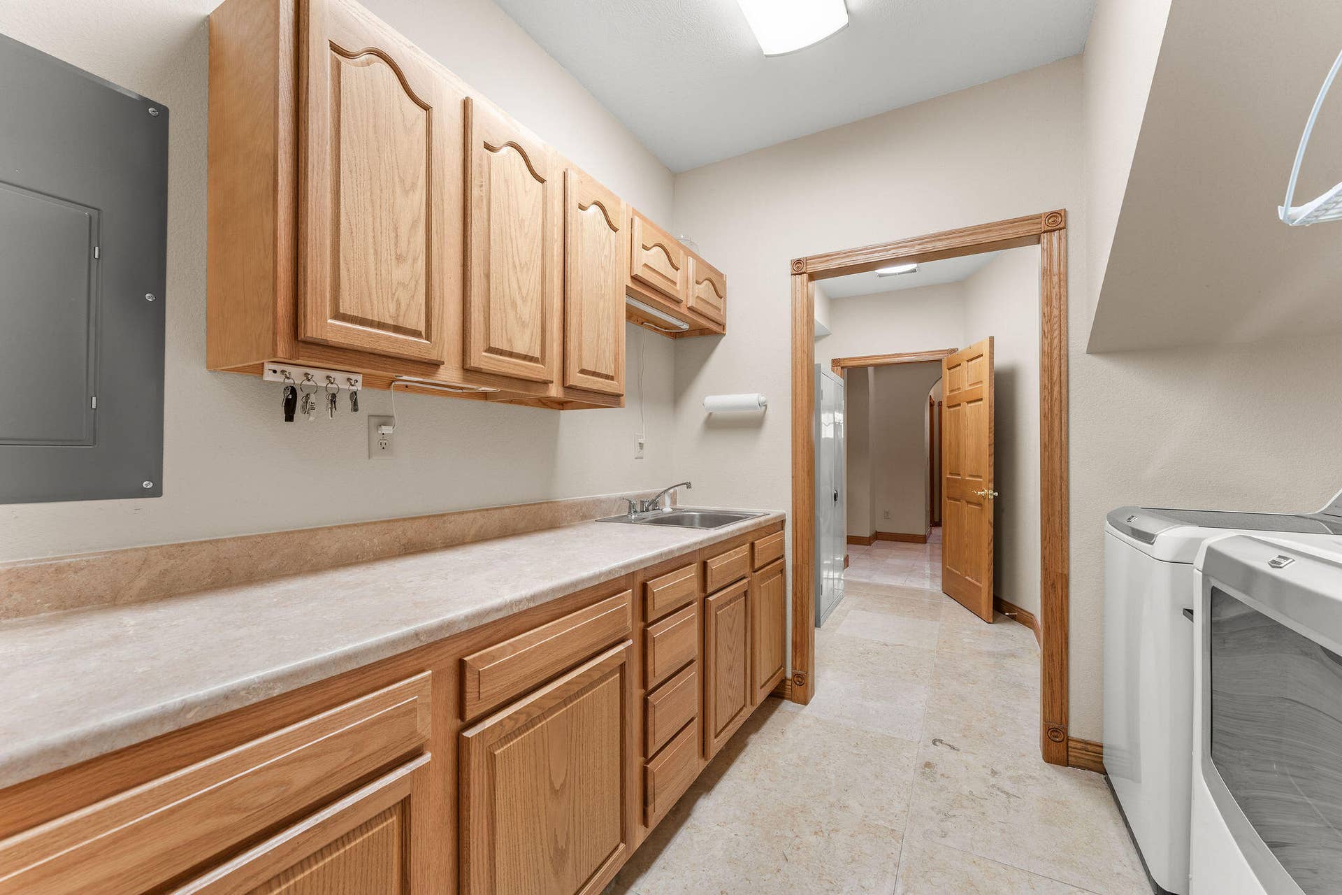 Laundry with cabinets and pantry
