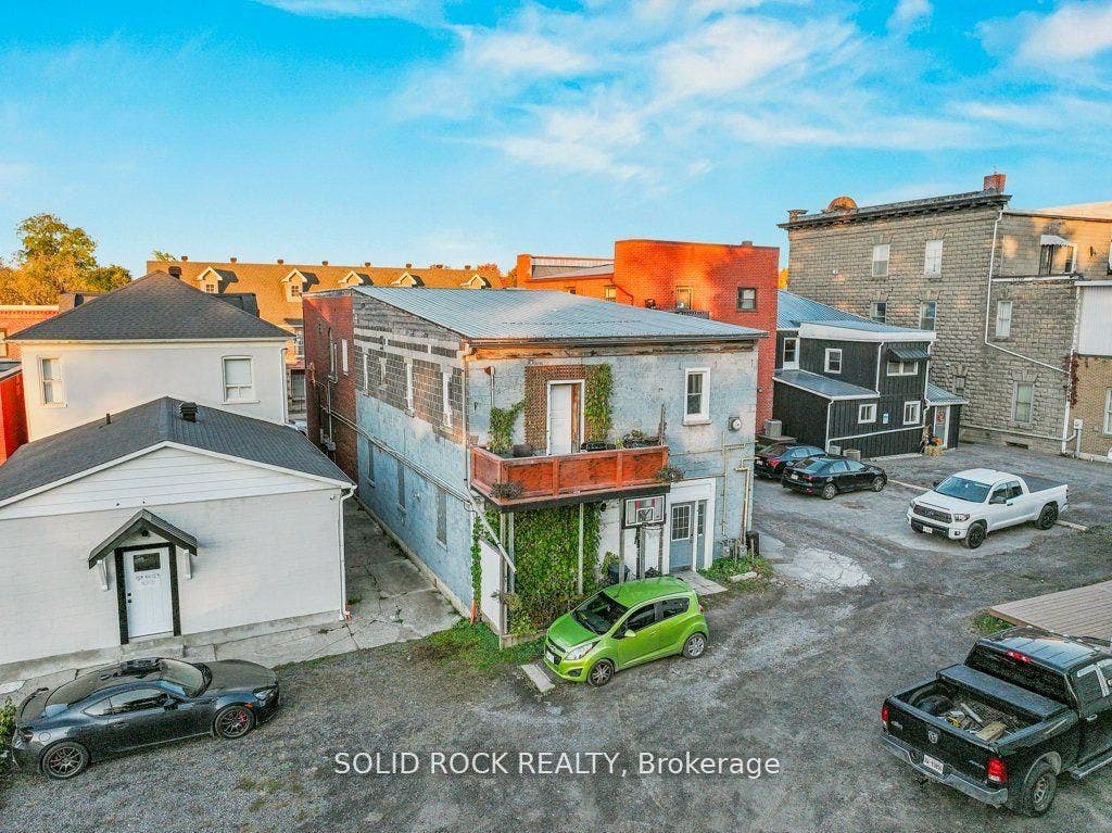 Rear of bldg showing parking area, lower right
